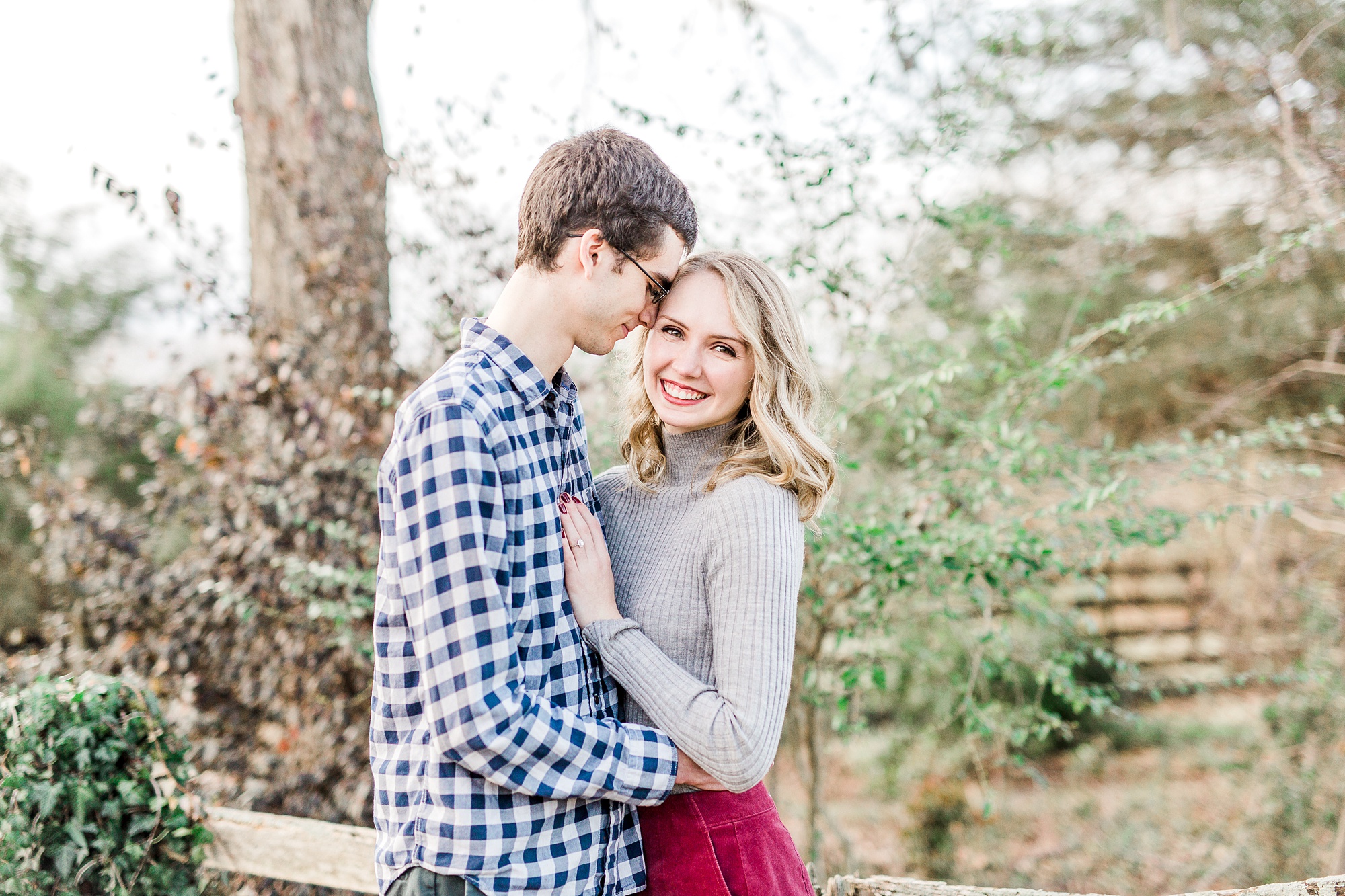 groom hugs bride during cozy 1812 Hitching Post engagement session