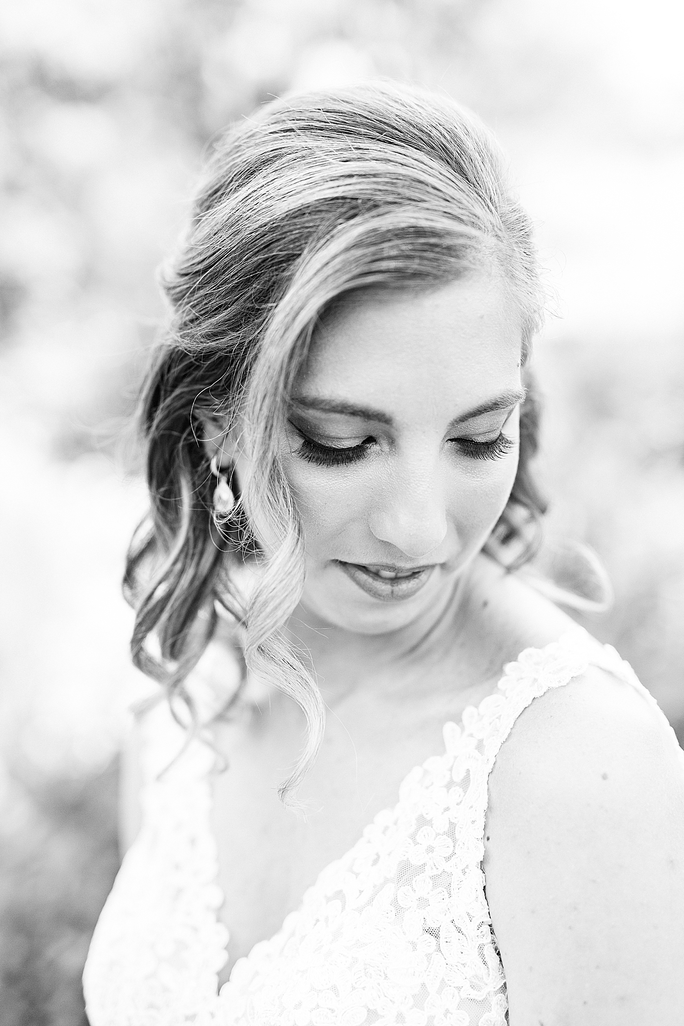 bride looks down over shoulder during Alexander Homestead bridal portraits