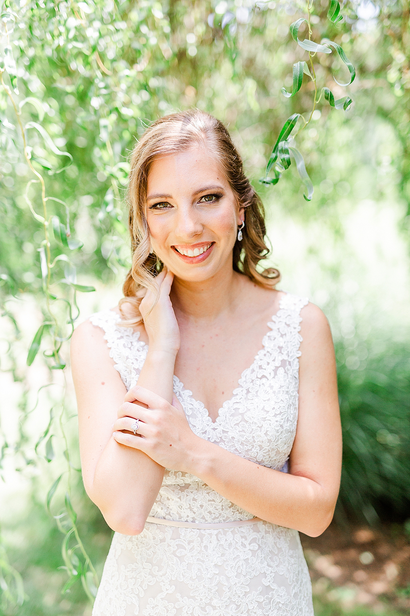 bride touches arm and neck during bridal session