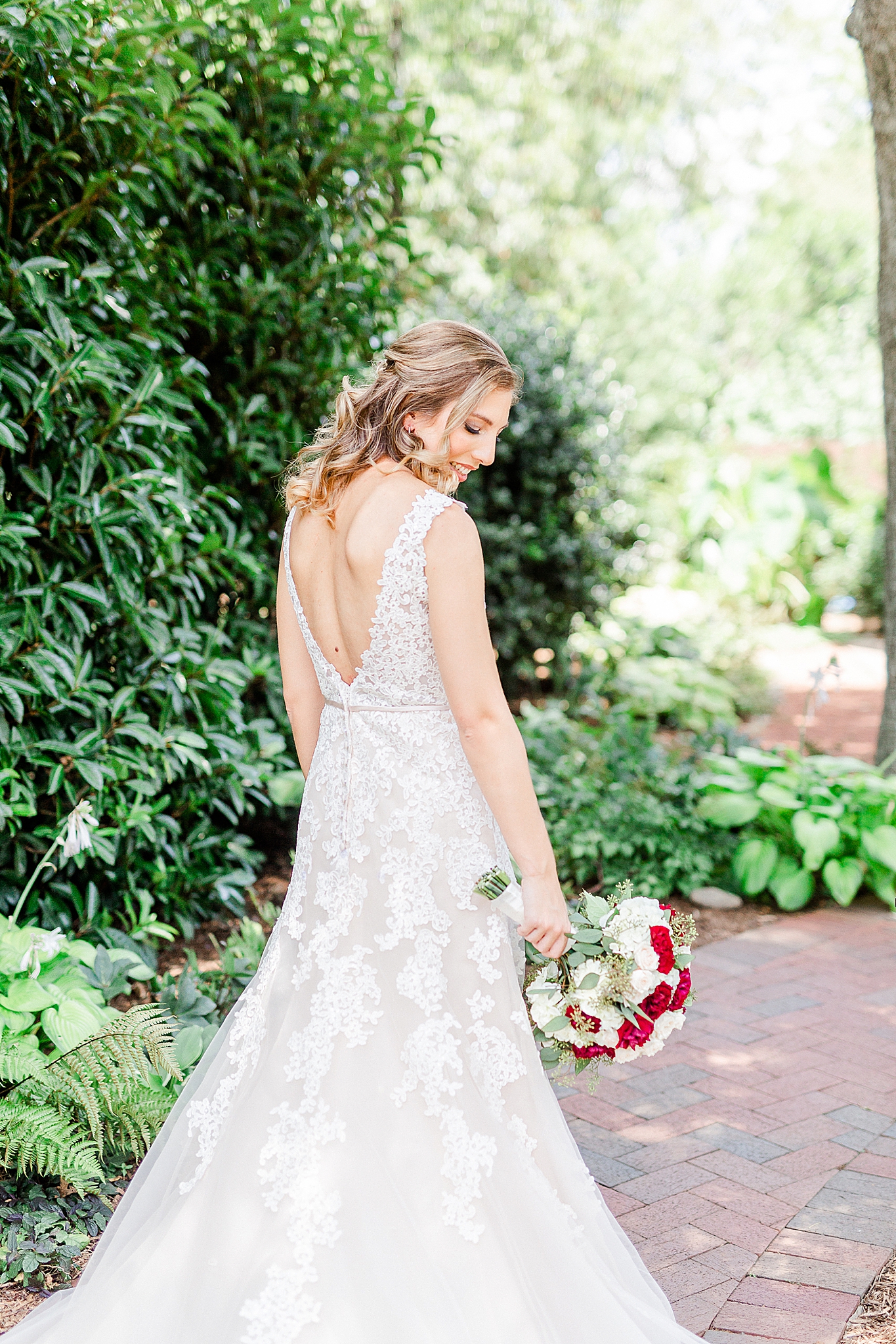 bride holds bouquet to the side