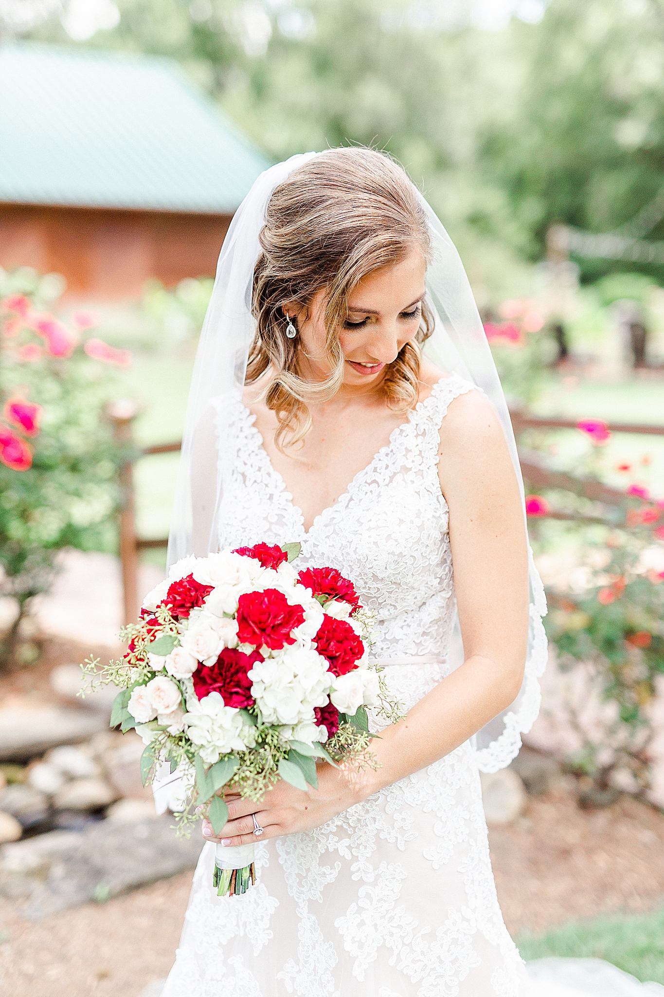 bride holds bouquet and looks over her shoulder during Alexander Homestead bridal portraits