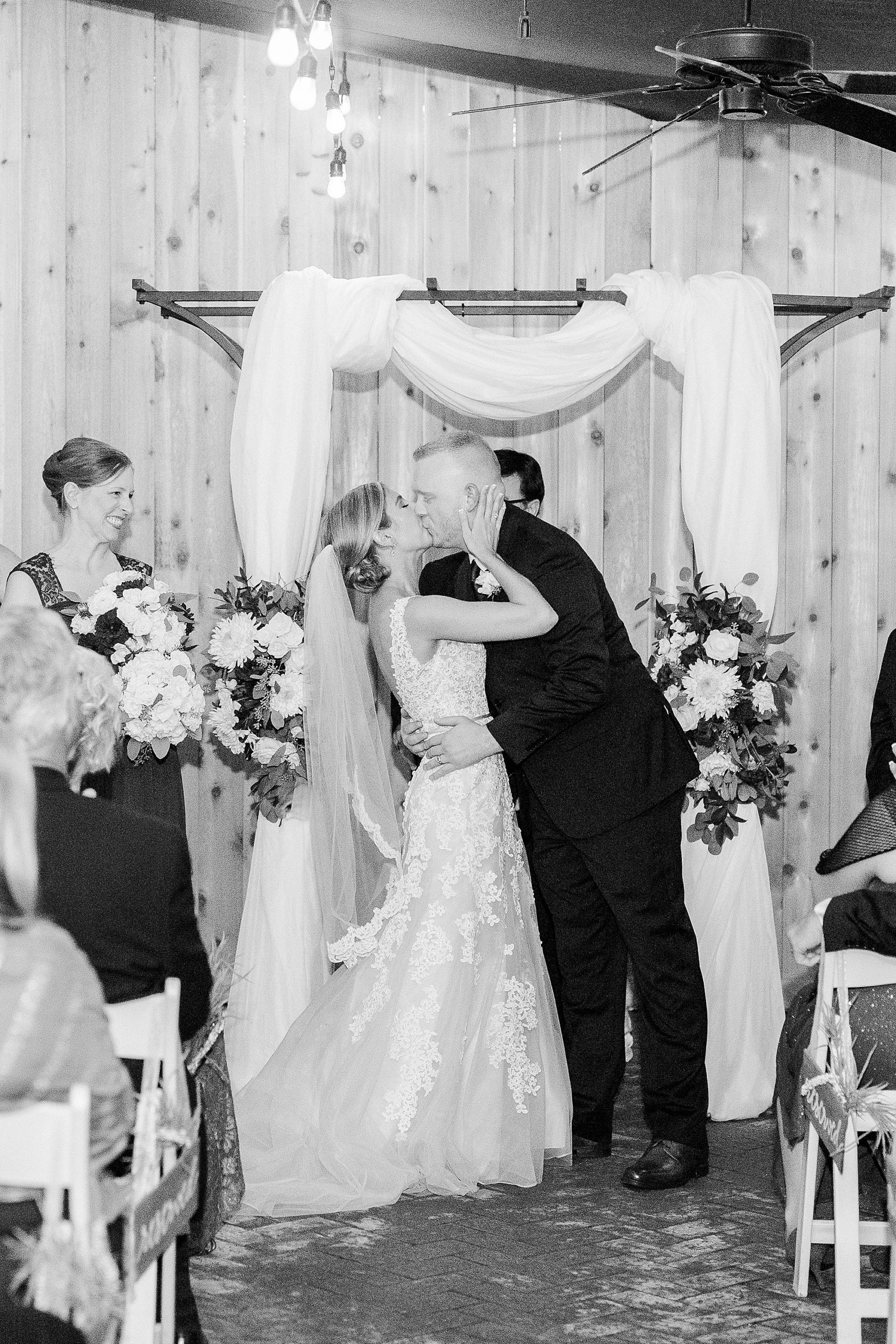 bride and groom kiss after ceremony