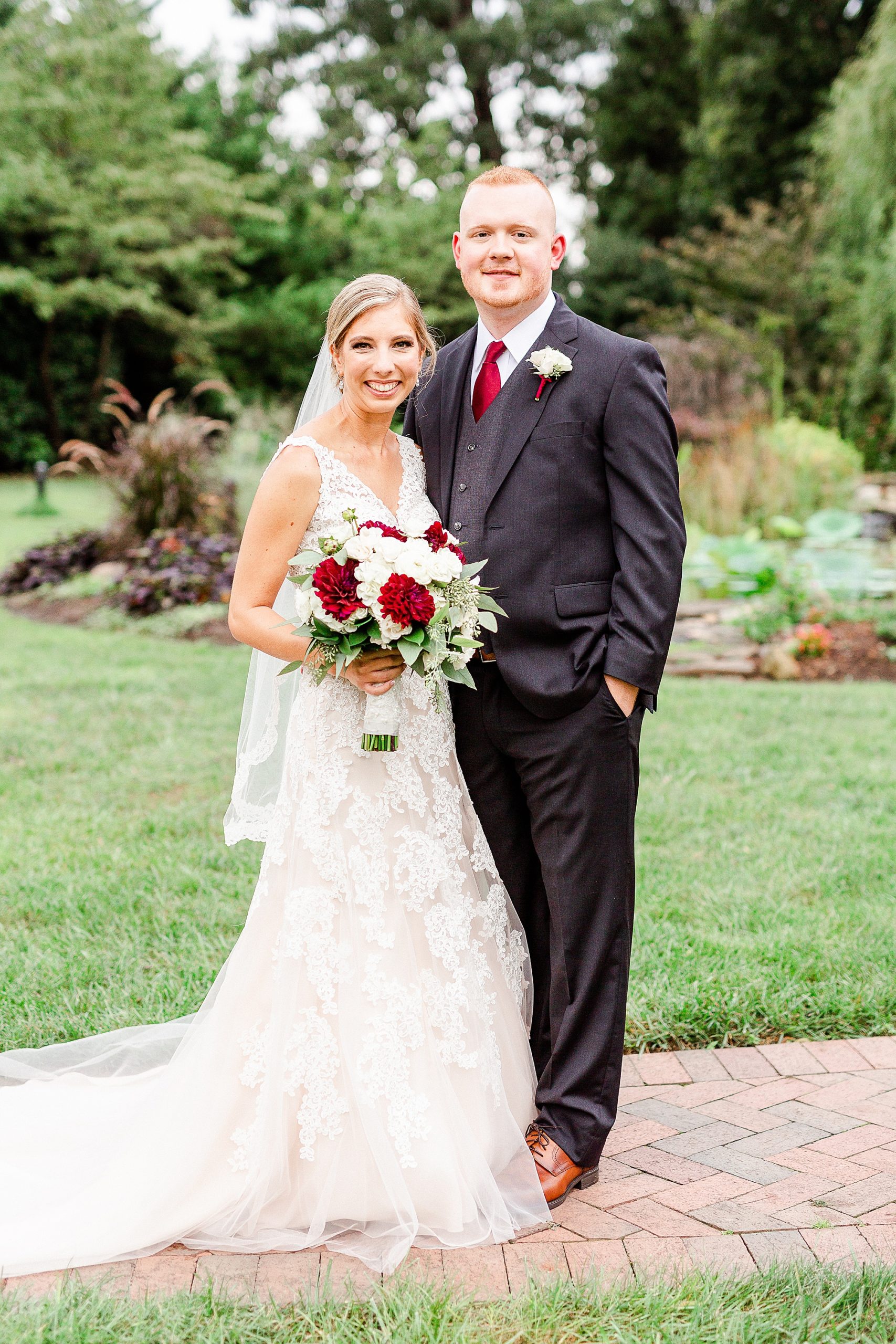 bride and groom pose on walkway at Alexander Homestead