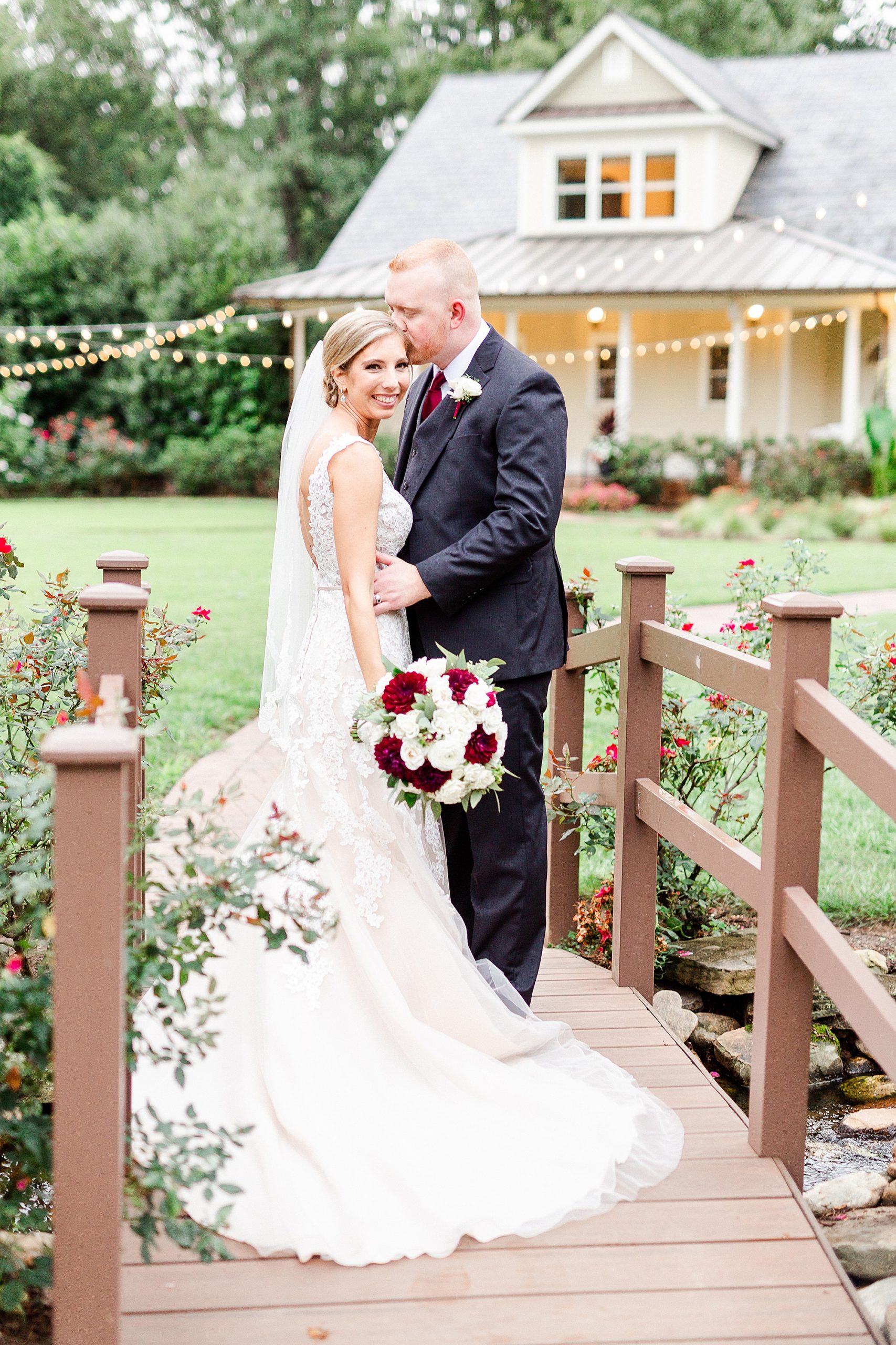 groom kisses bride's forehead at Alexander Homestead