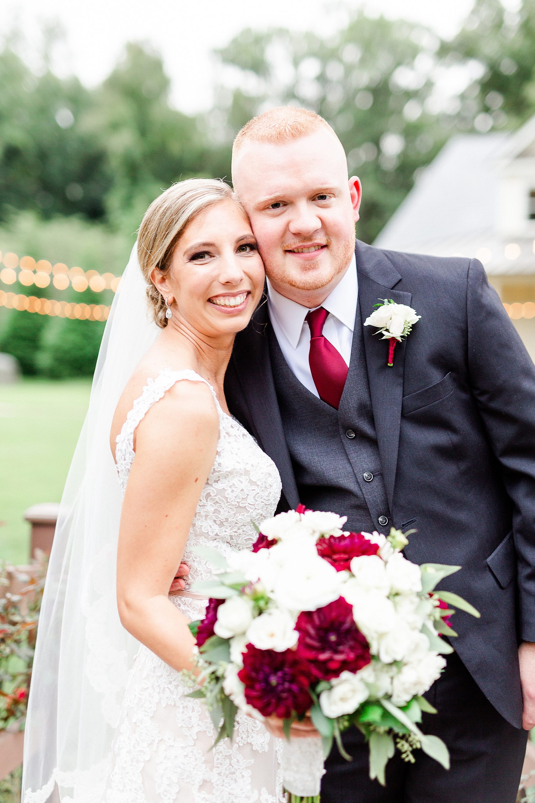 bride and groom stand with heads touching