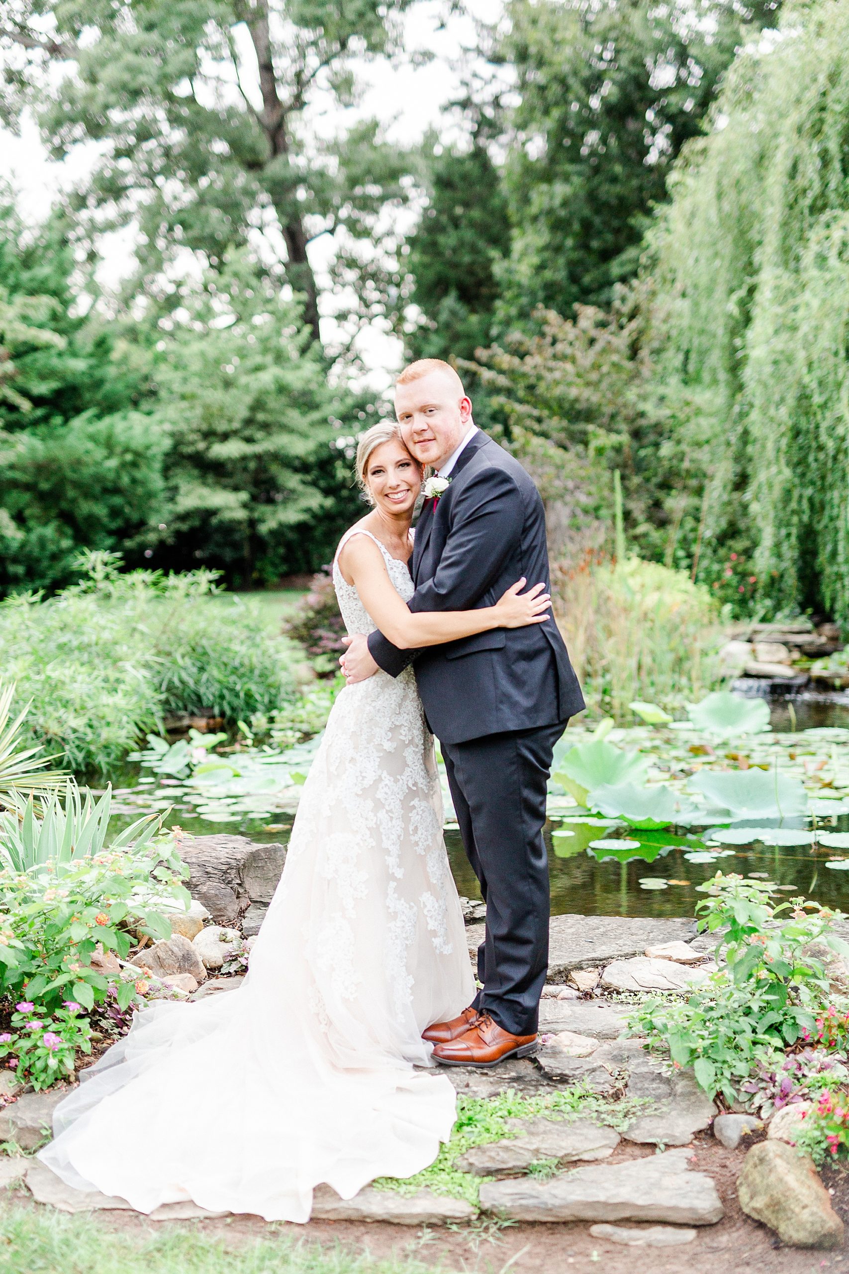 newlyweds hug in garden at Alexander Homestead