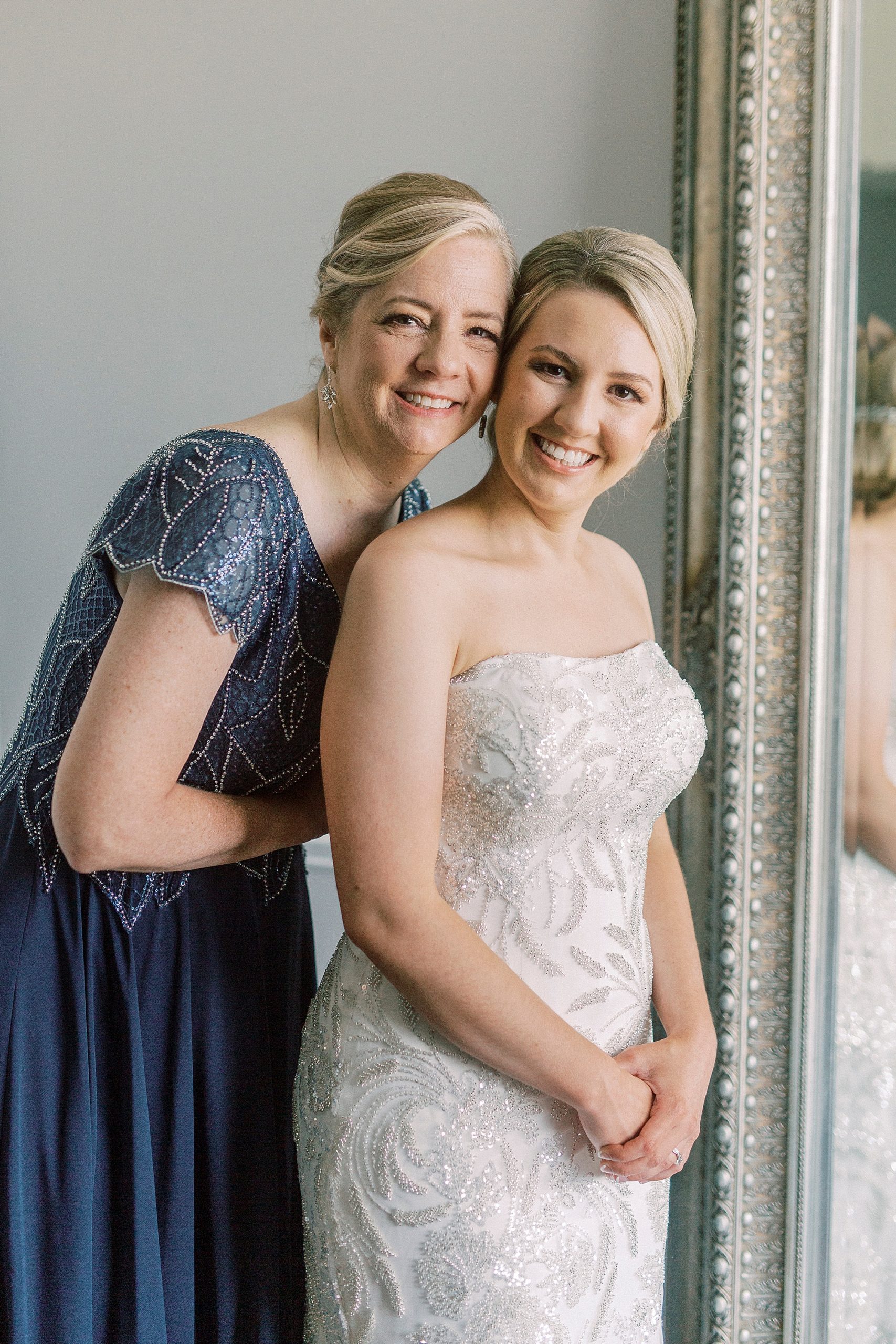 mom and bride hug during wedding day prep