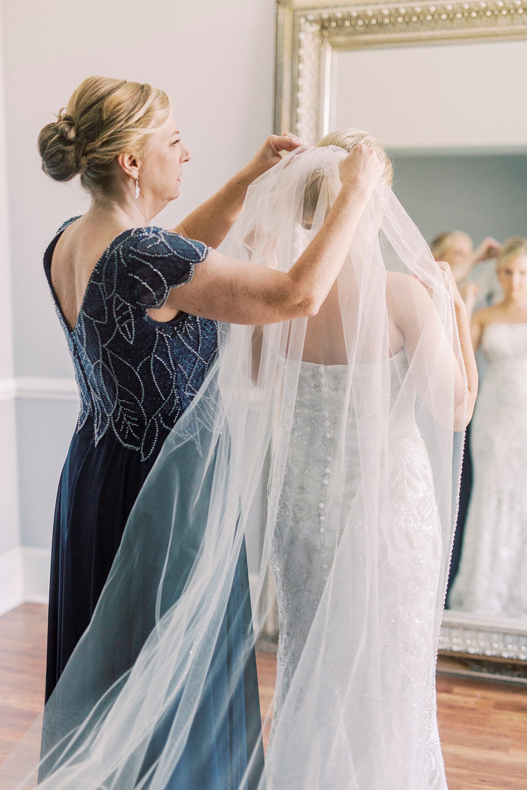 mother of bride helps with veil