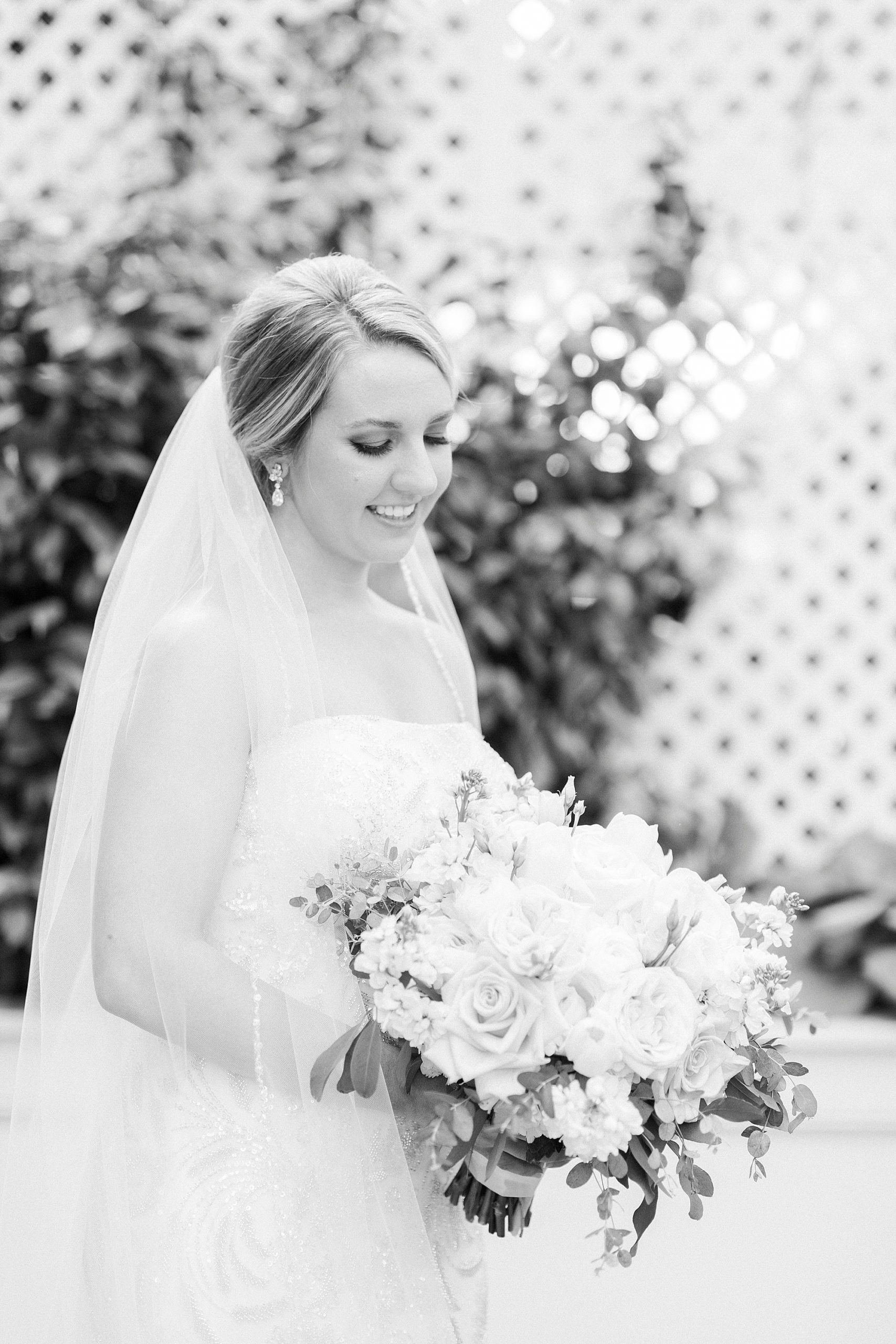 bride looks down at bouquet during bridal portraits