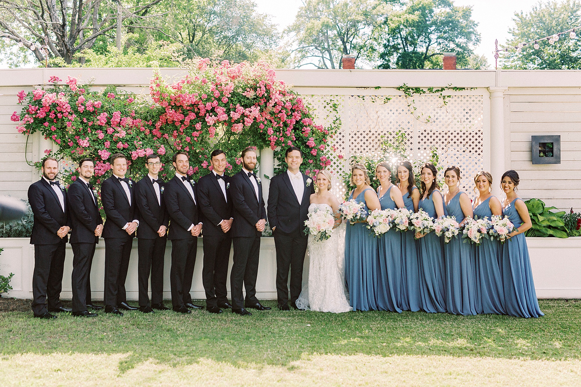 bride and groom pose with wedding party