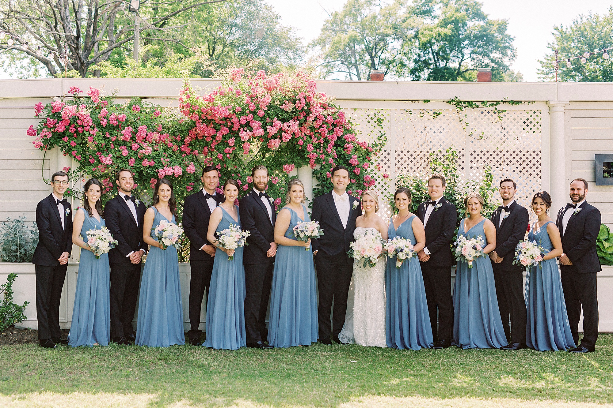 newlyweds pose with wedding party outside Separk Mansion