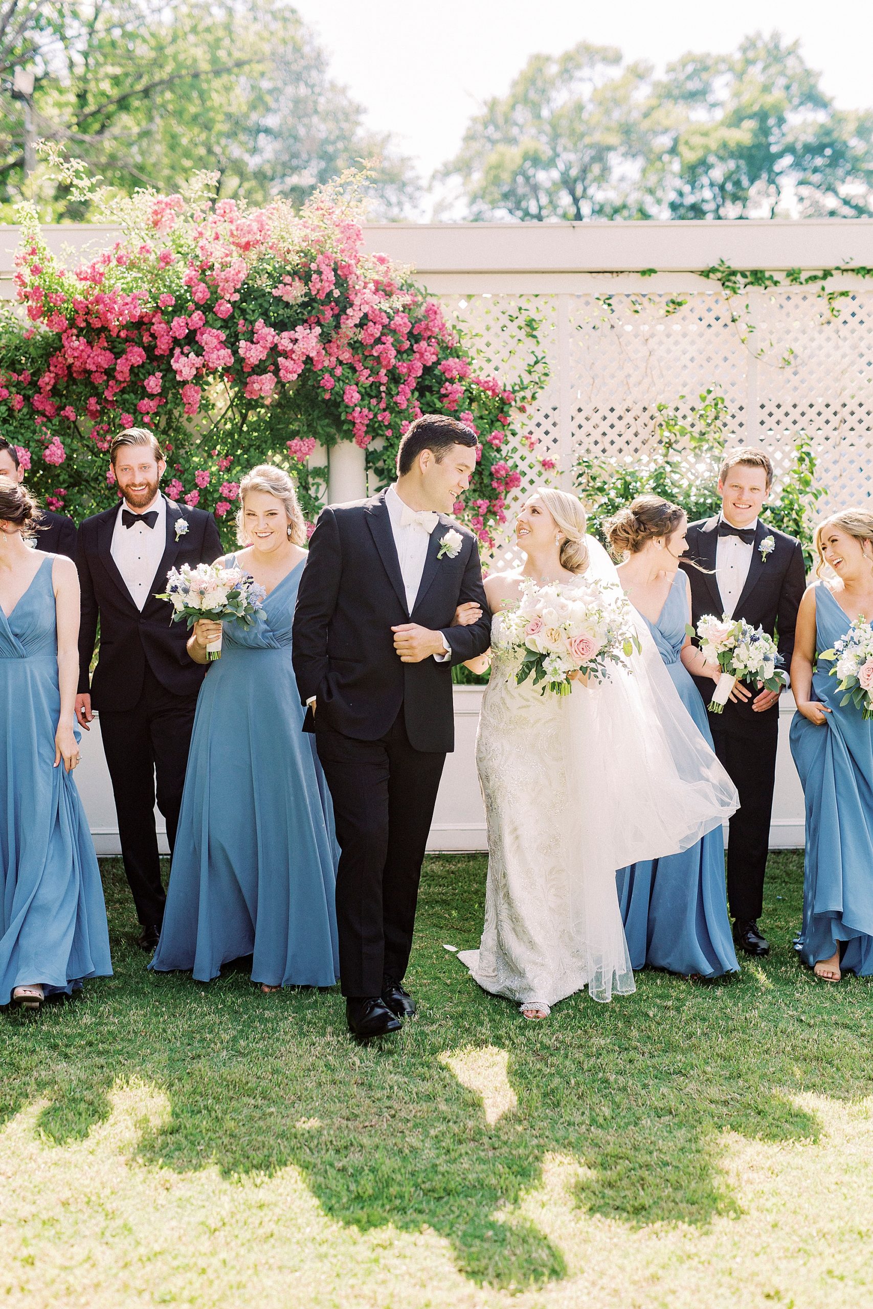 newlyweds walk with groomsmen and bridesmaids outside Separk Mansion