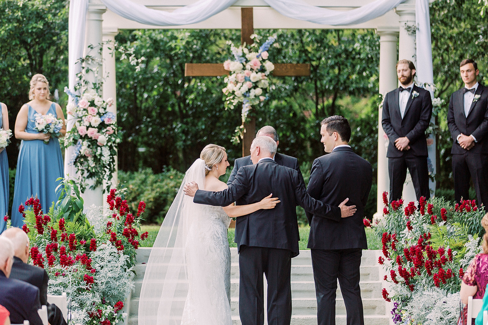 father gives bride away during outdoor wedding ceremony at Separk Mansion