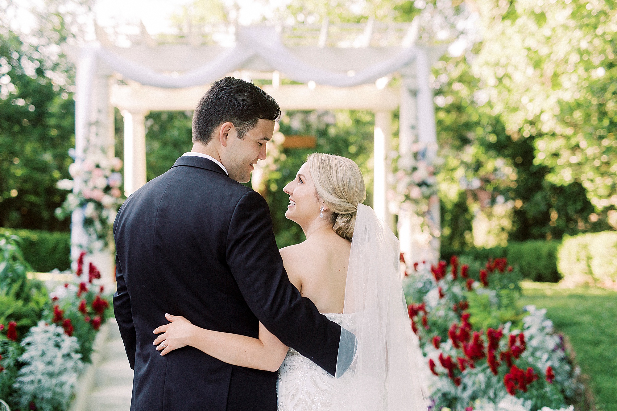bride and groom hug by ceremony site at Separk Mansion