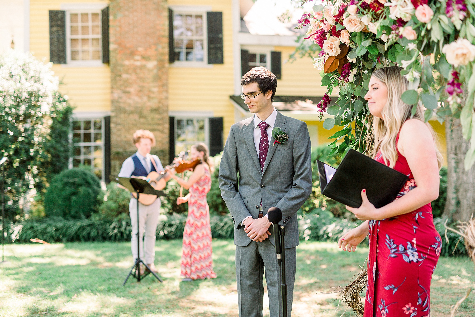 groom watches bride down aisle at 1812 Hitching Post wedding ceremony