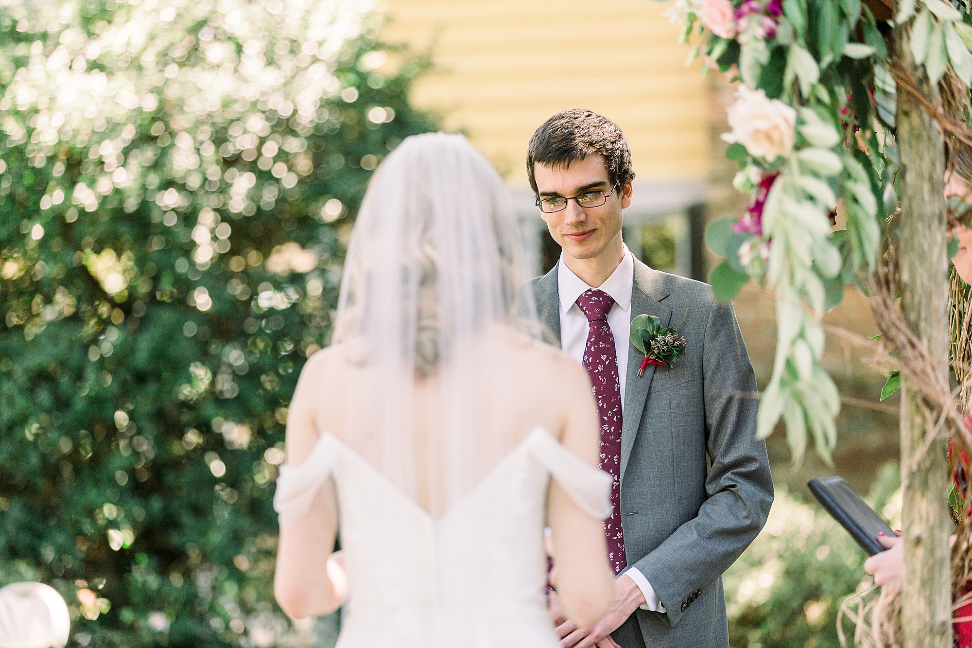 groom looks at bride during wedding ceremony at 1812 Hitching Post