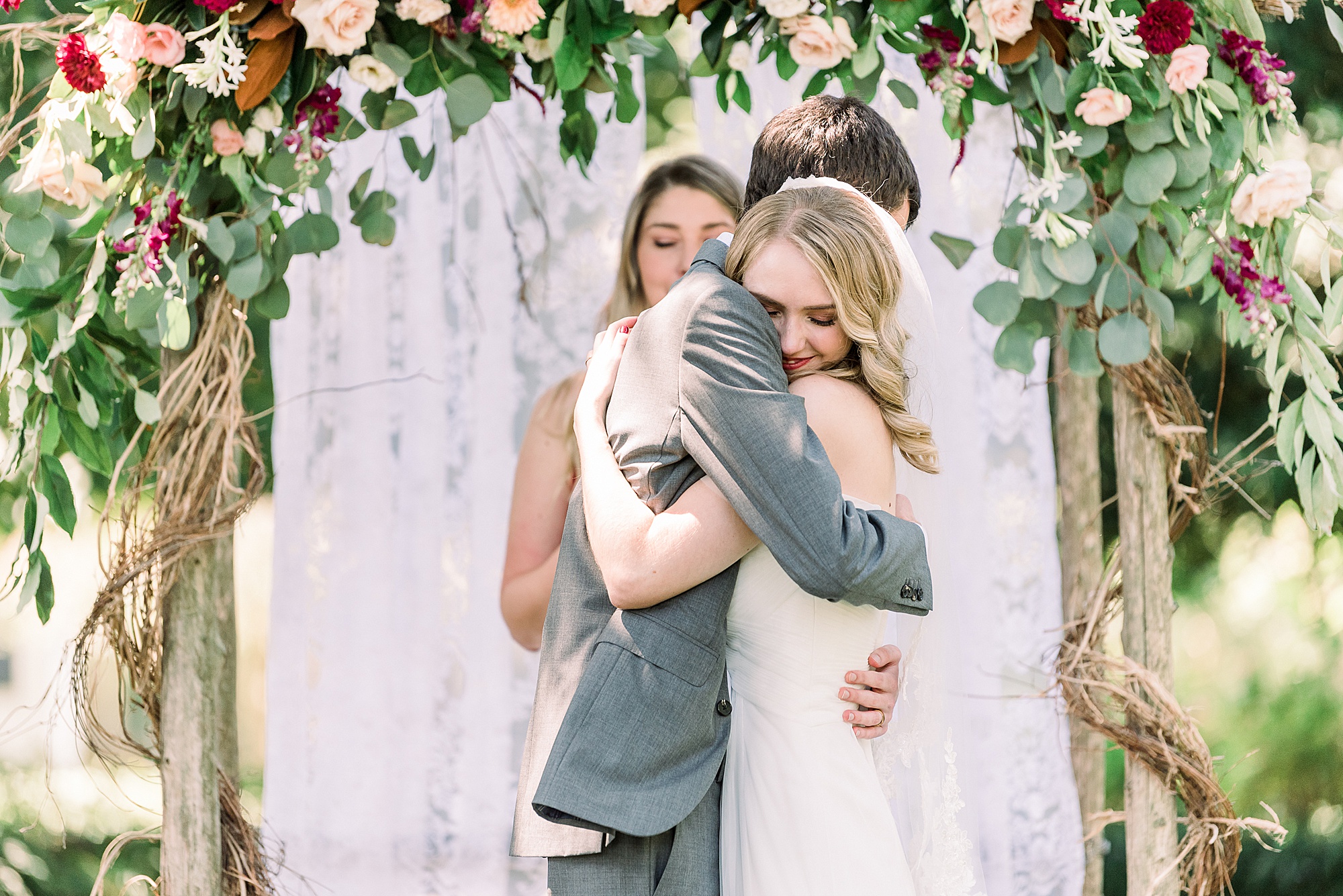 newlyweds hug after ceremony at 1812 Hitching Post