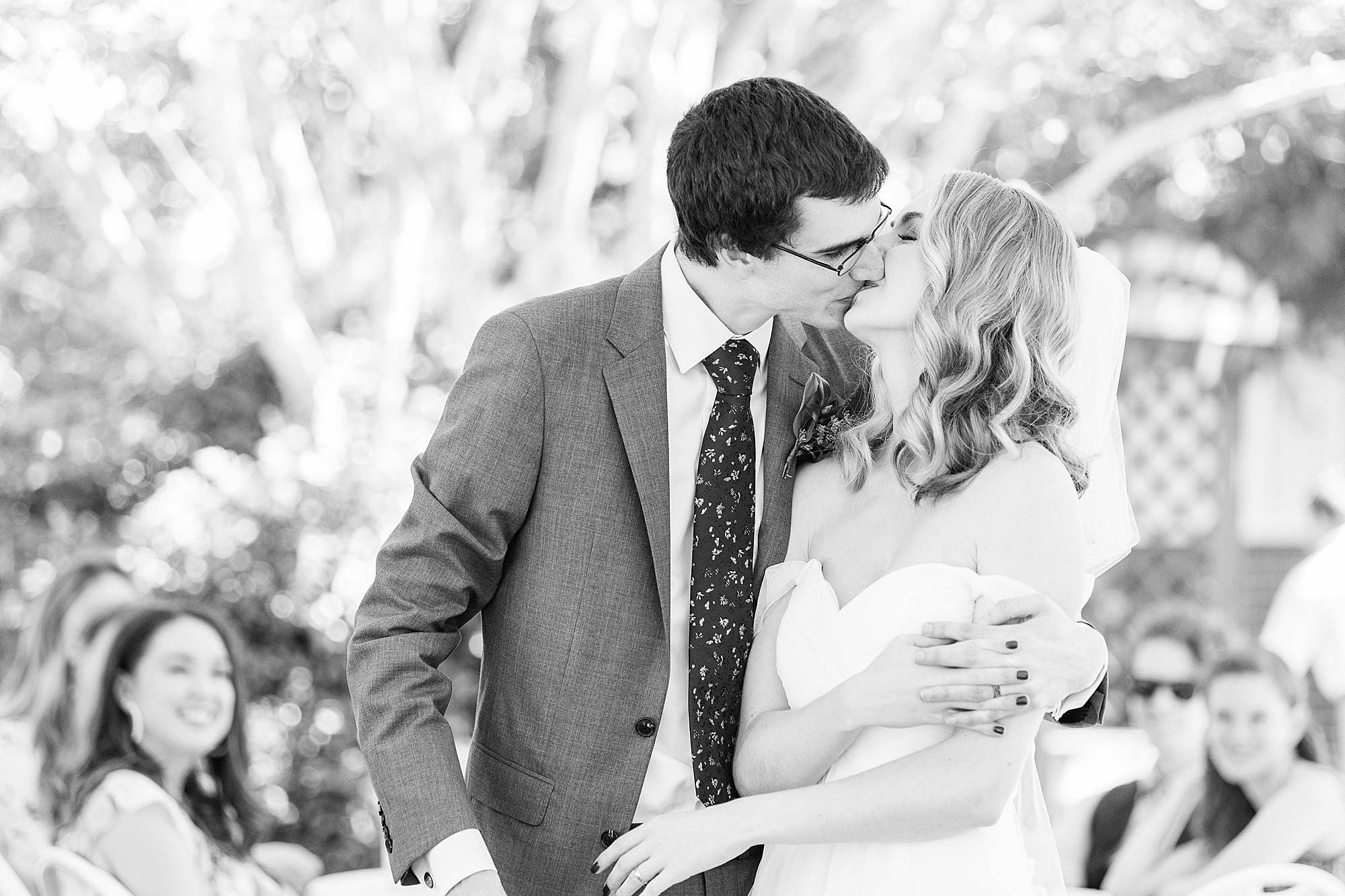 bride and groom kiss cutting cake