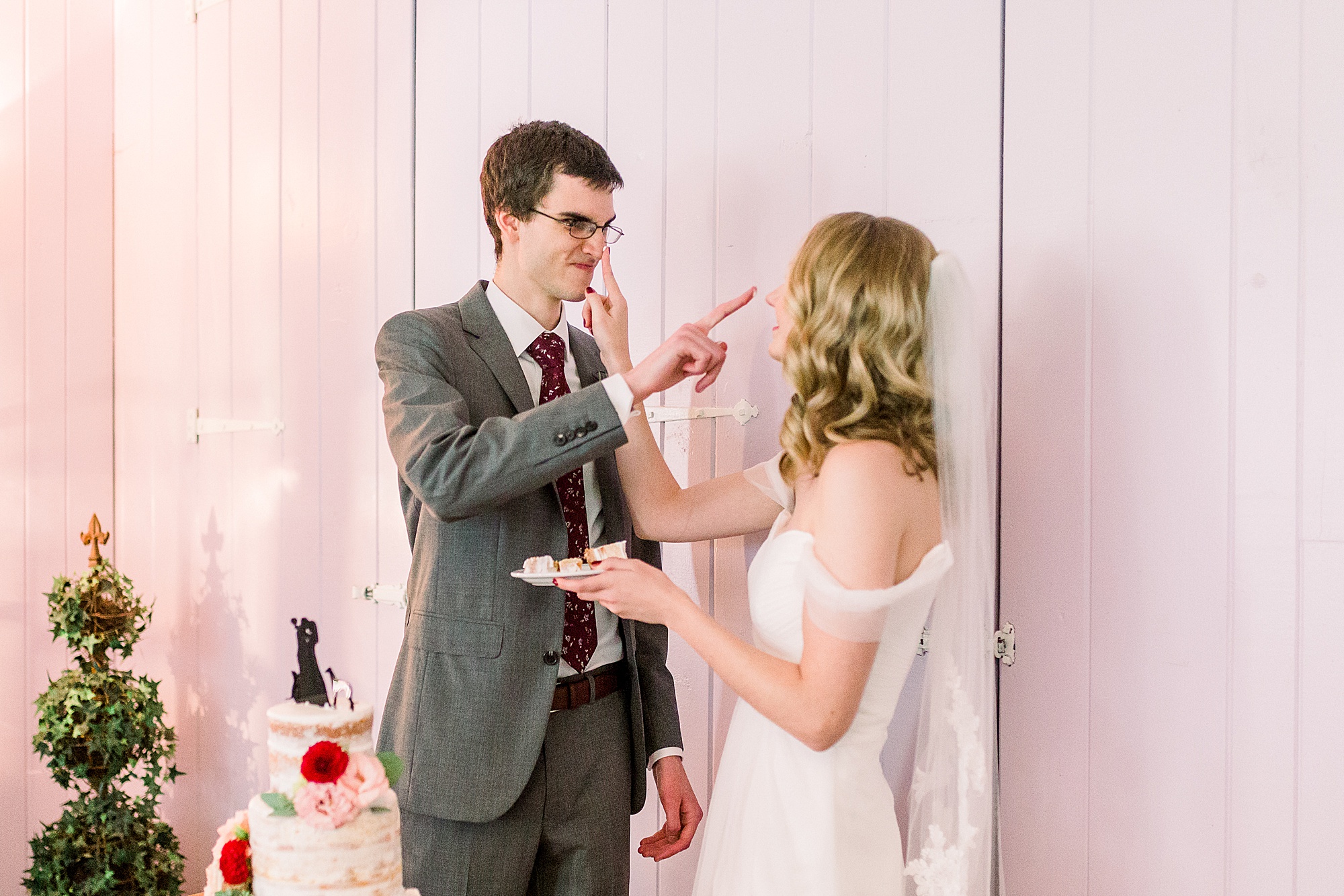newlyweds cut wedding cake at 1812 Hitching Post