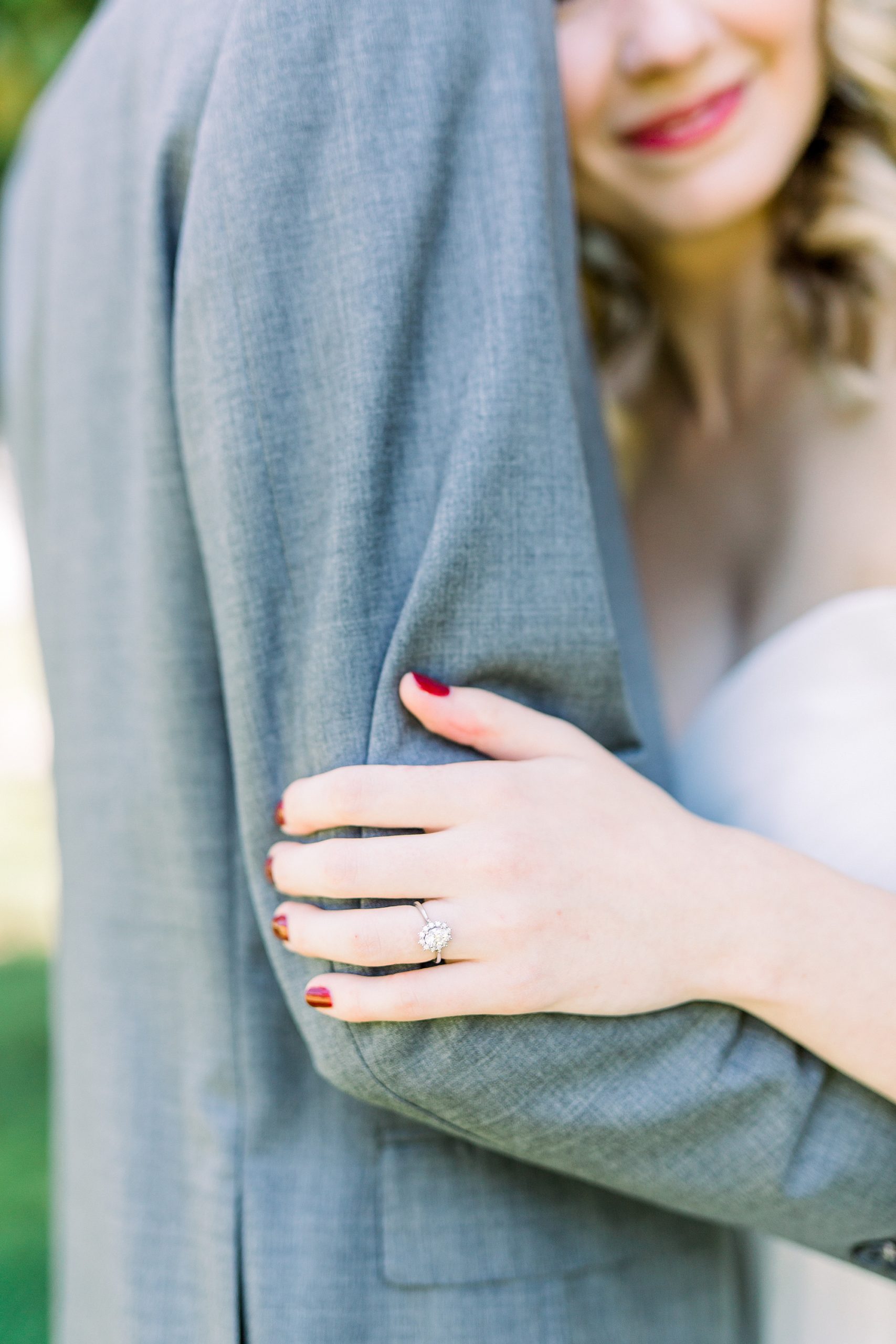 bride holds groom's arm during NC wedding photos