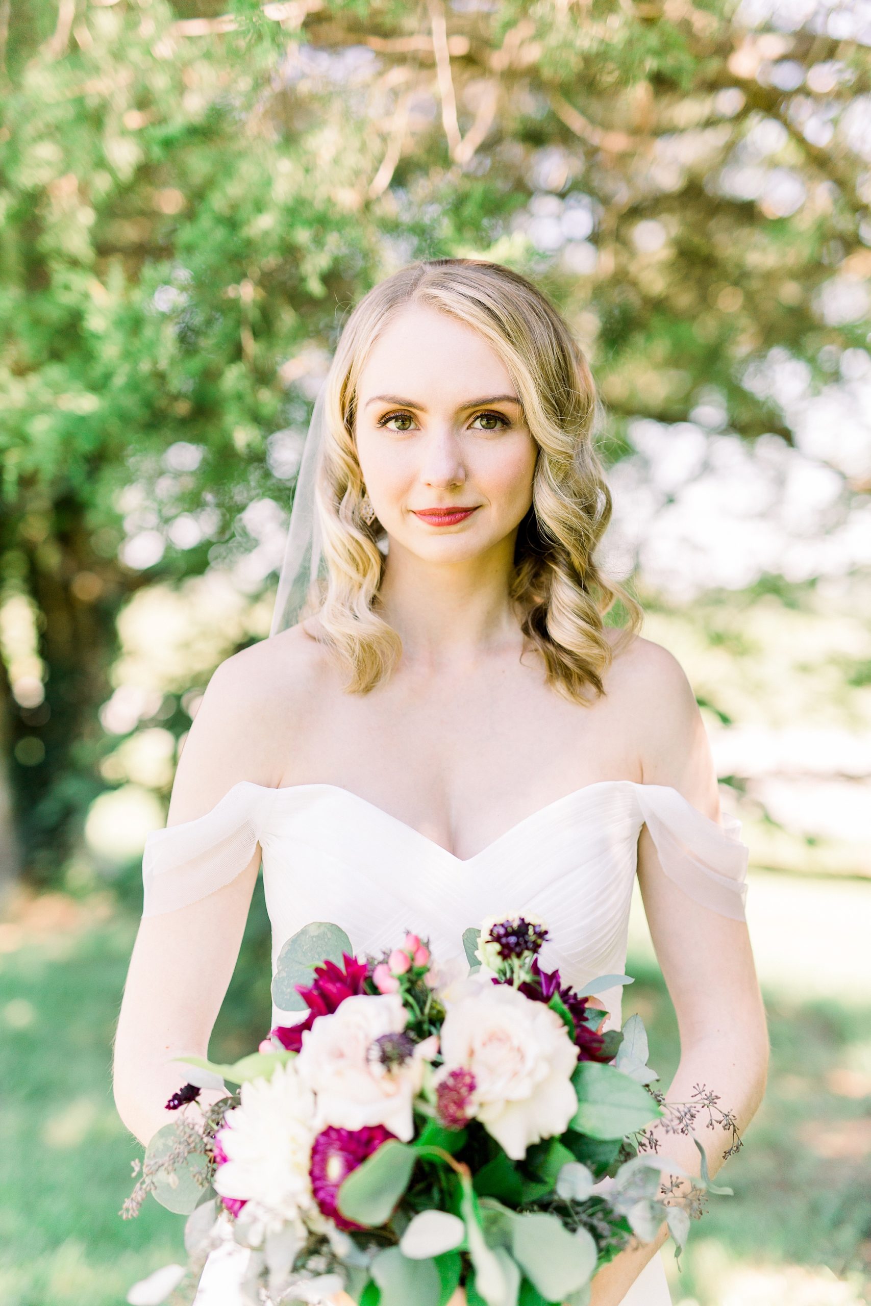bride holds bouquet of fall flowers