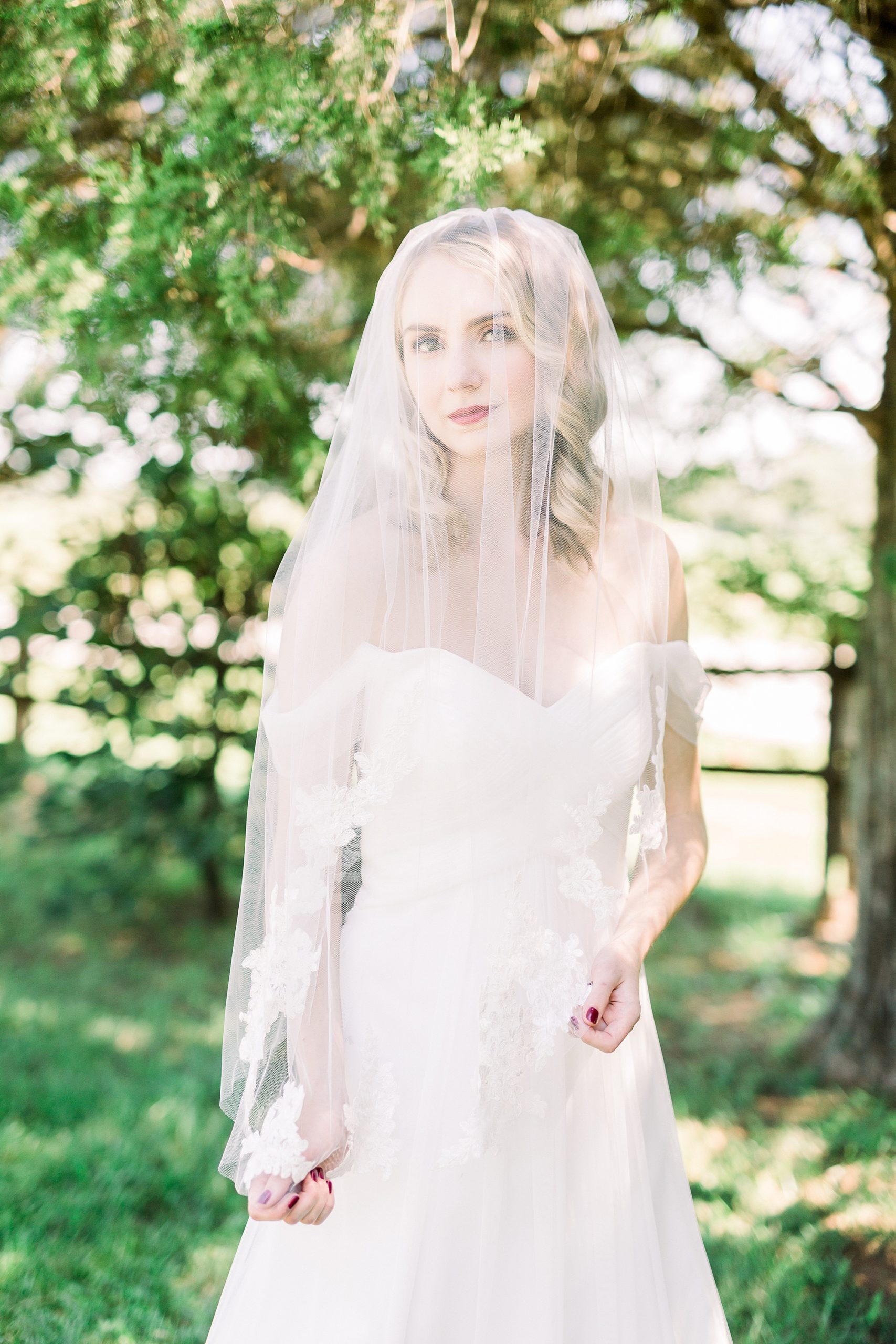bride smiles under veil at 1812 Hitching Post