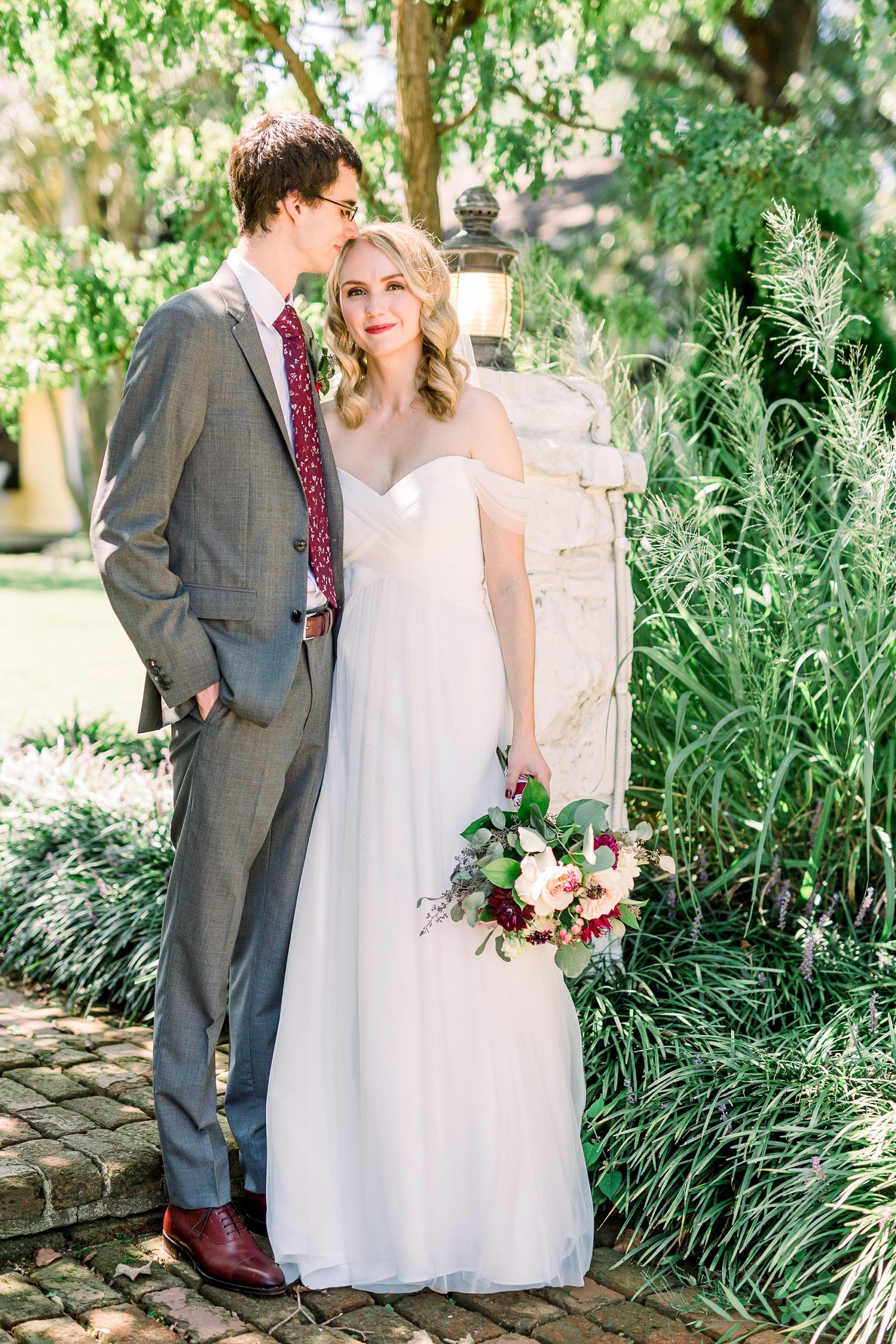 groom kisses bride's forehead