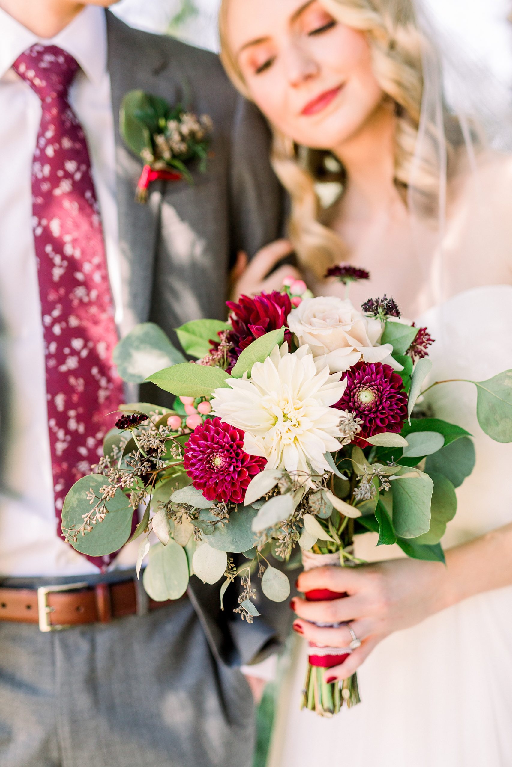 bride holds bouquet of summer florals