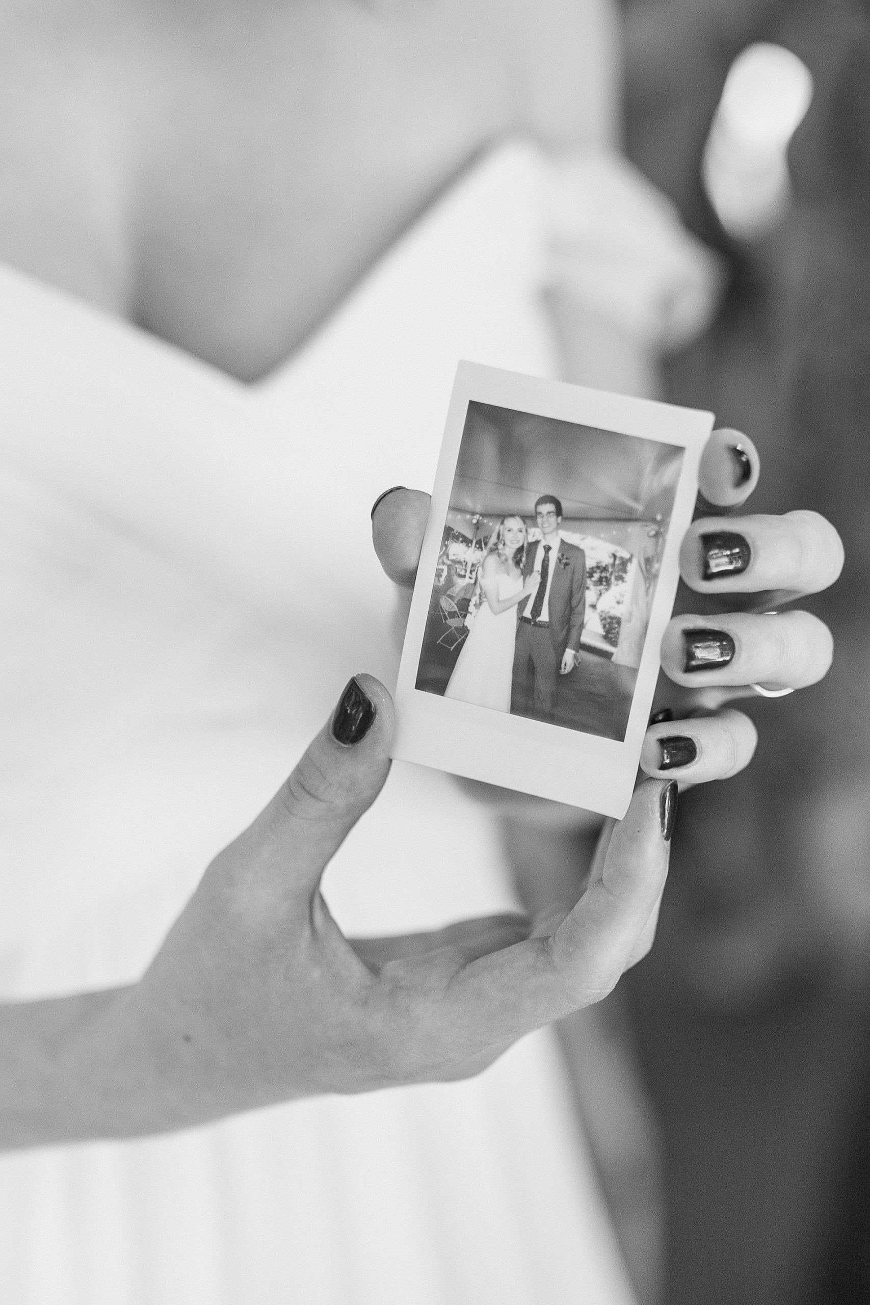 bride holds polaroid during Harmony NC wedding reception