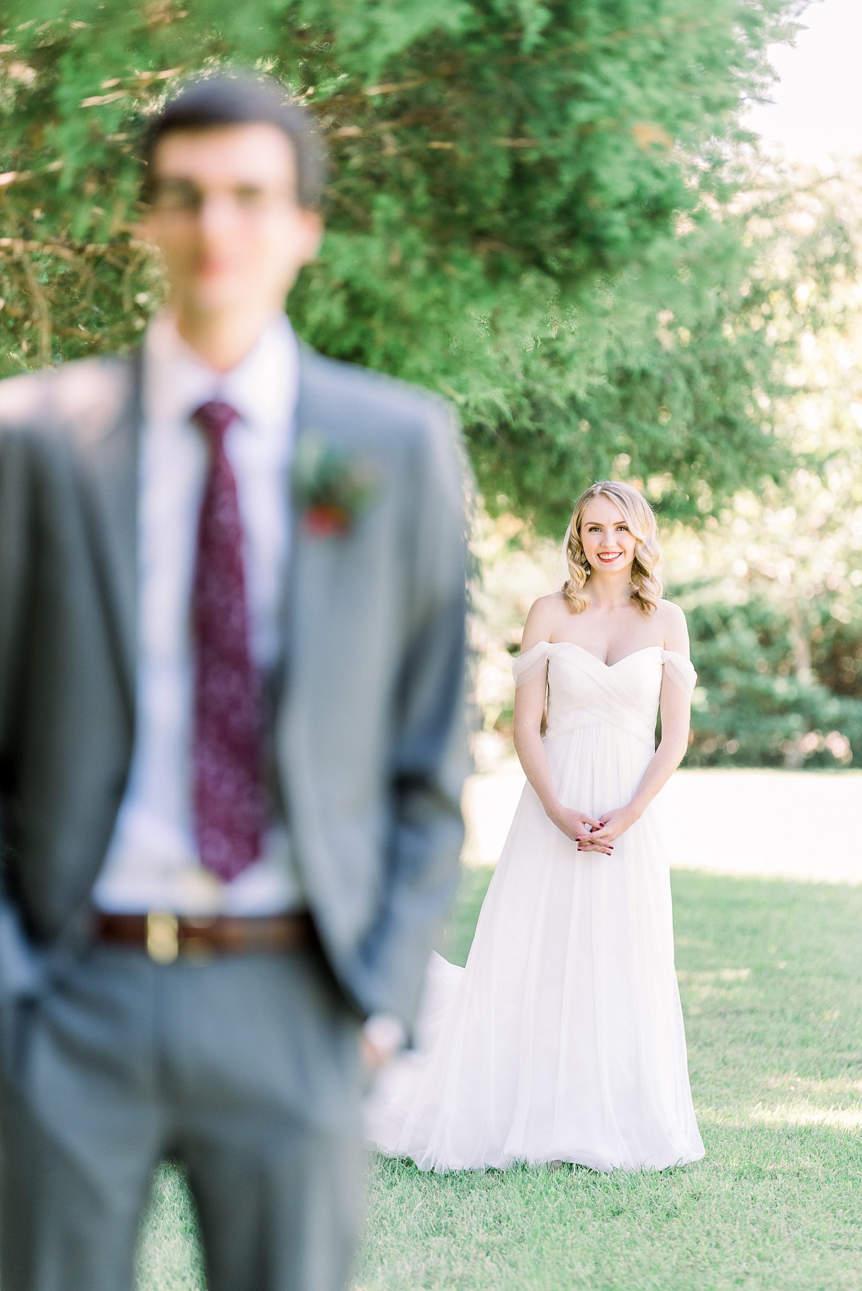 bride walks towards groom during first look