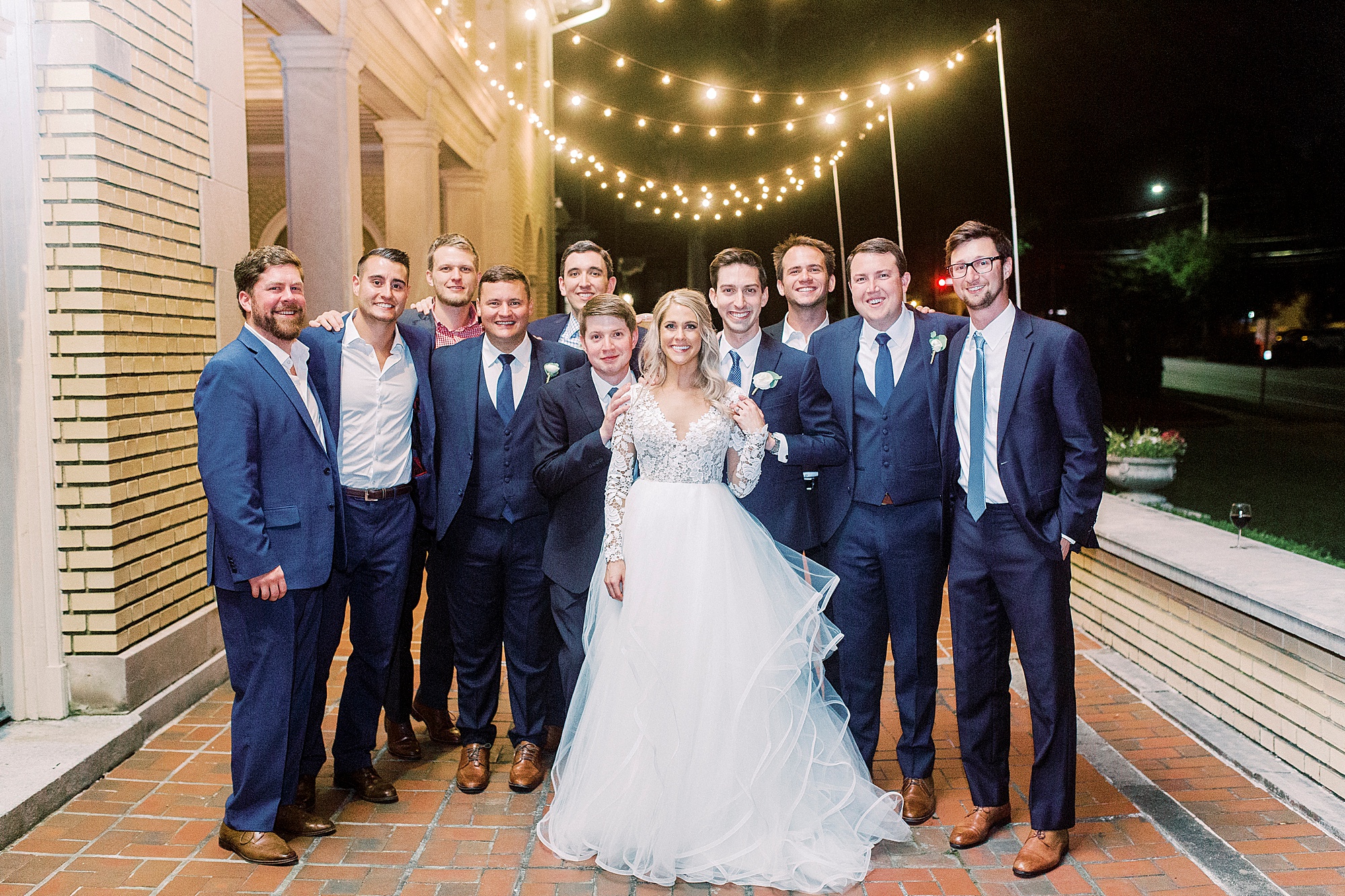 bride poses with groomsmen