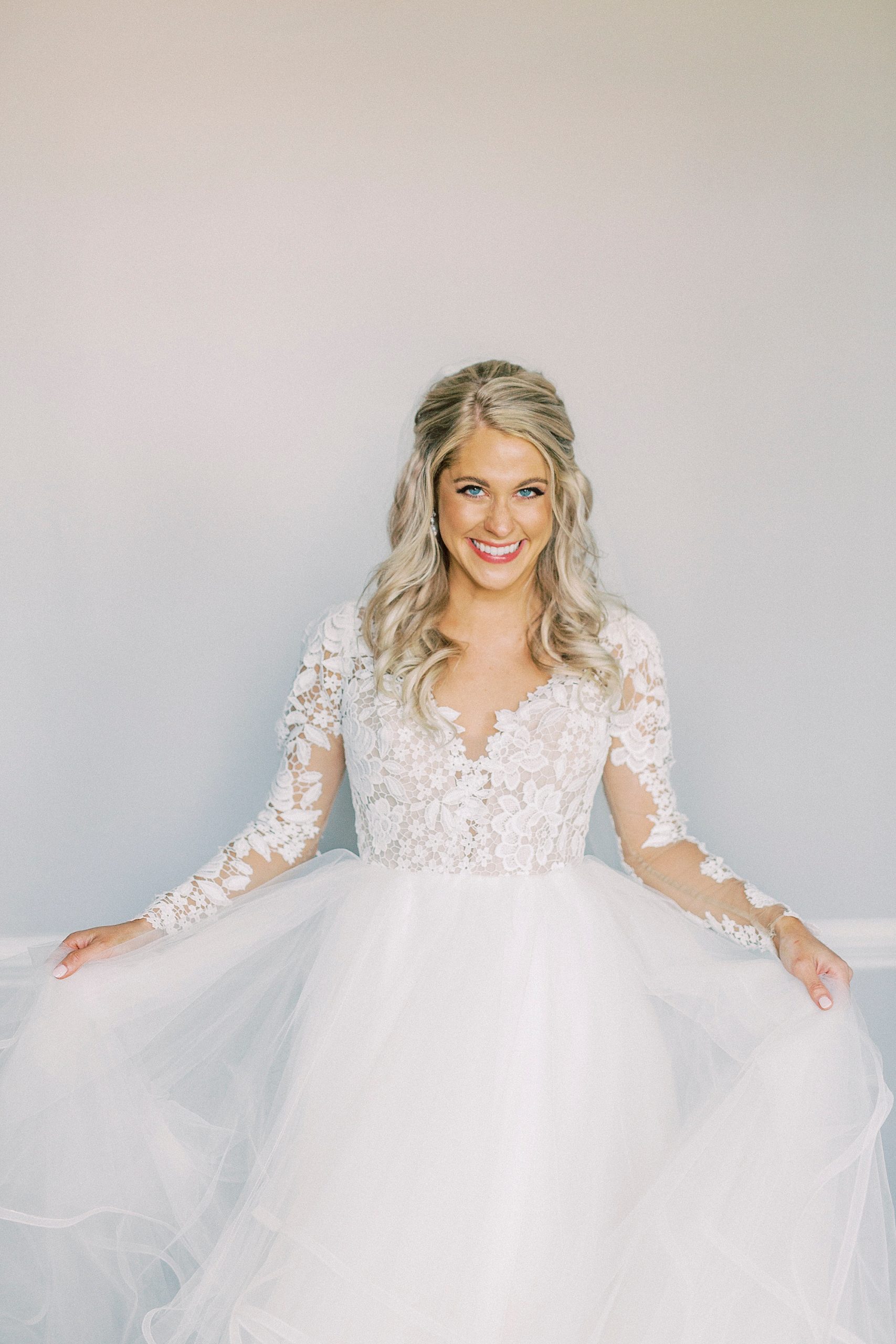bride shows off skirt of hayden olivia bridal gown