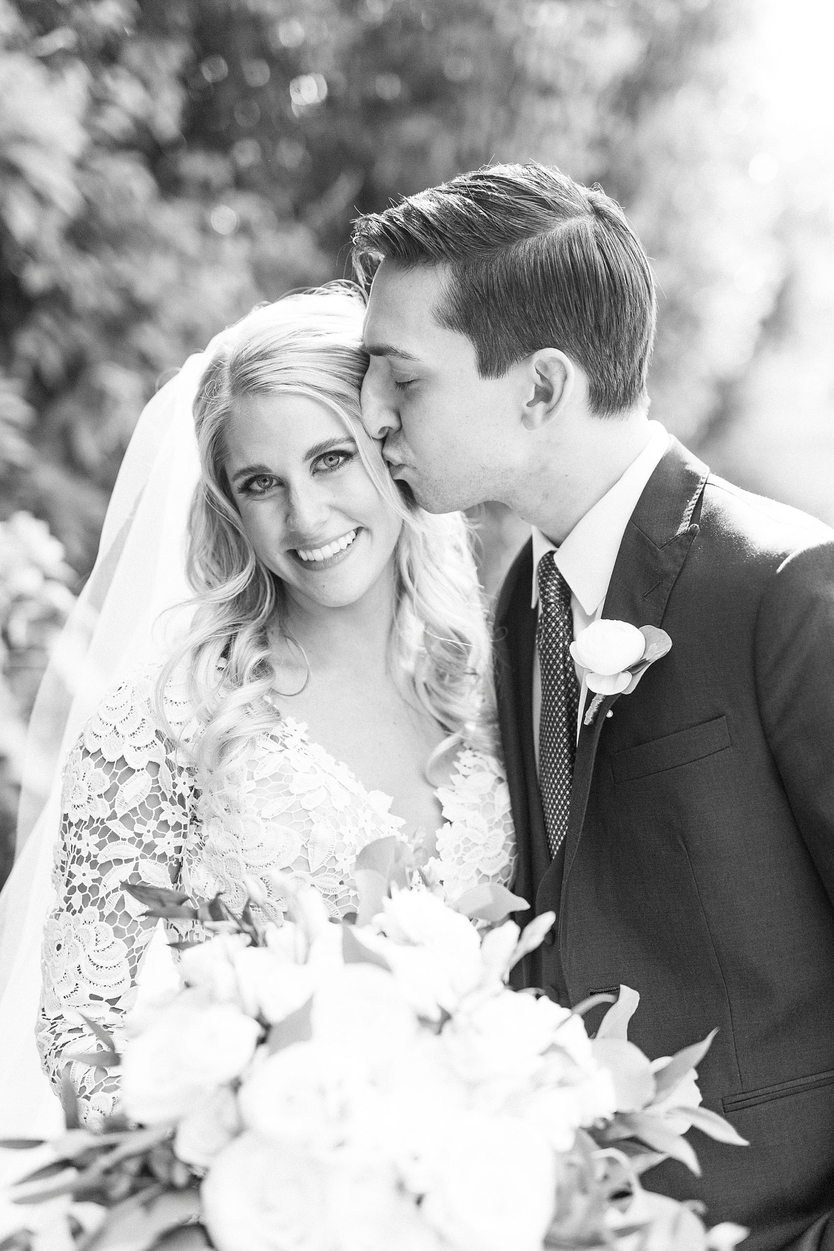 groom kisses bride's cheek during portraits at Separk Mansion