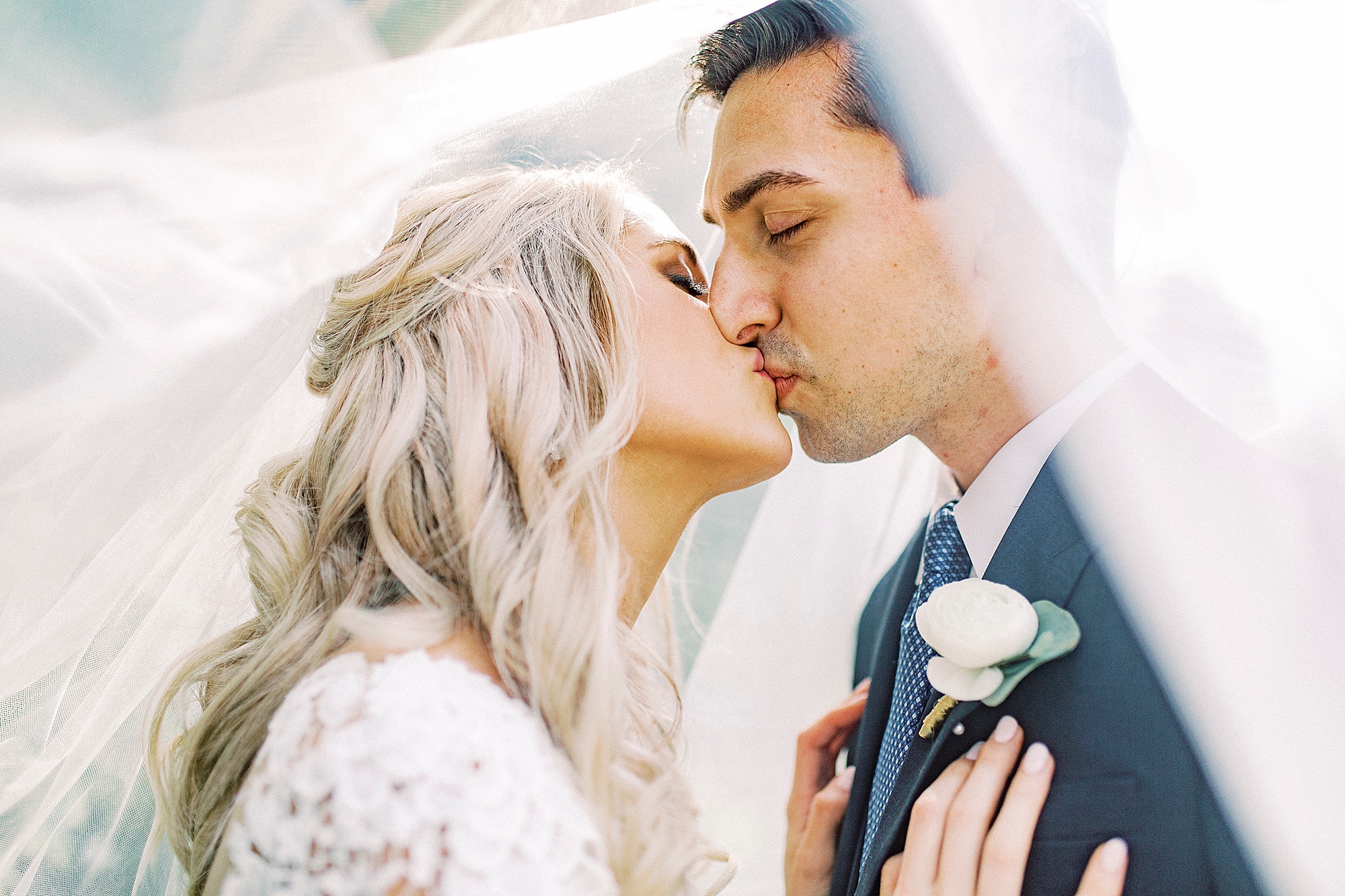 bride and groom kiss during wedding photos in Charlotte NC