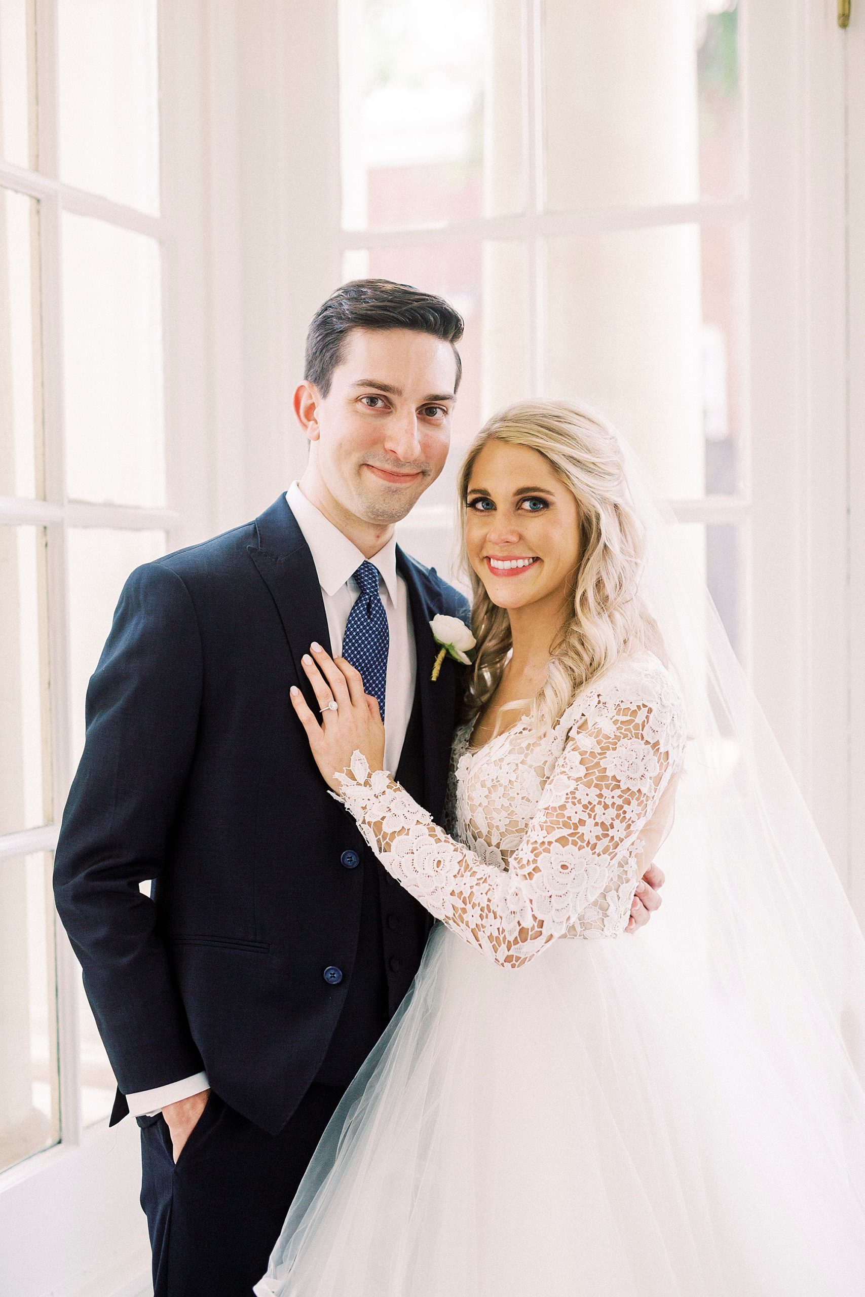 bride and groom pose in patio room of Separk Mansion