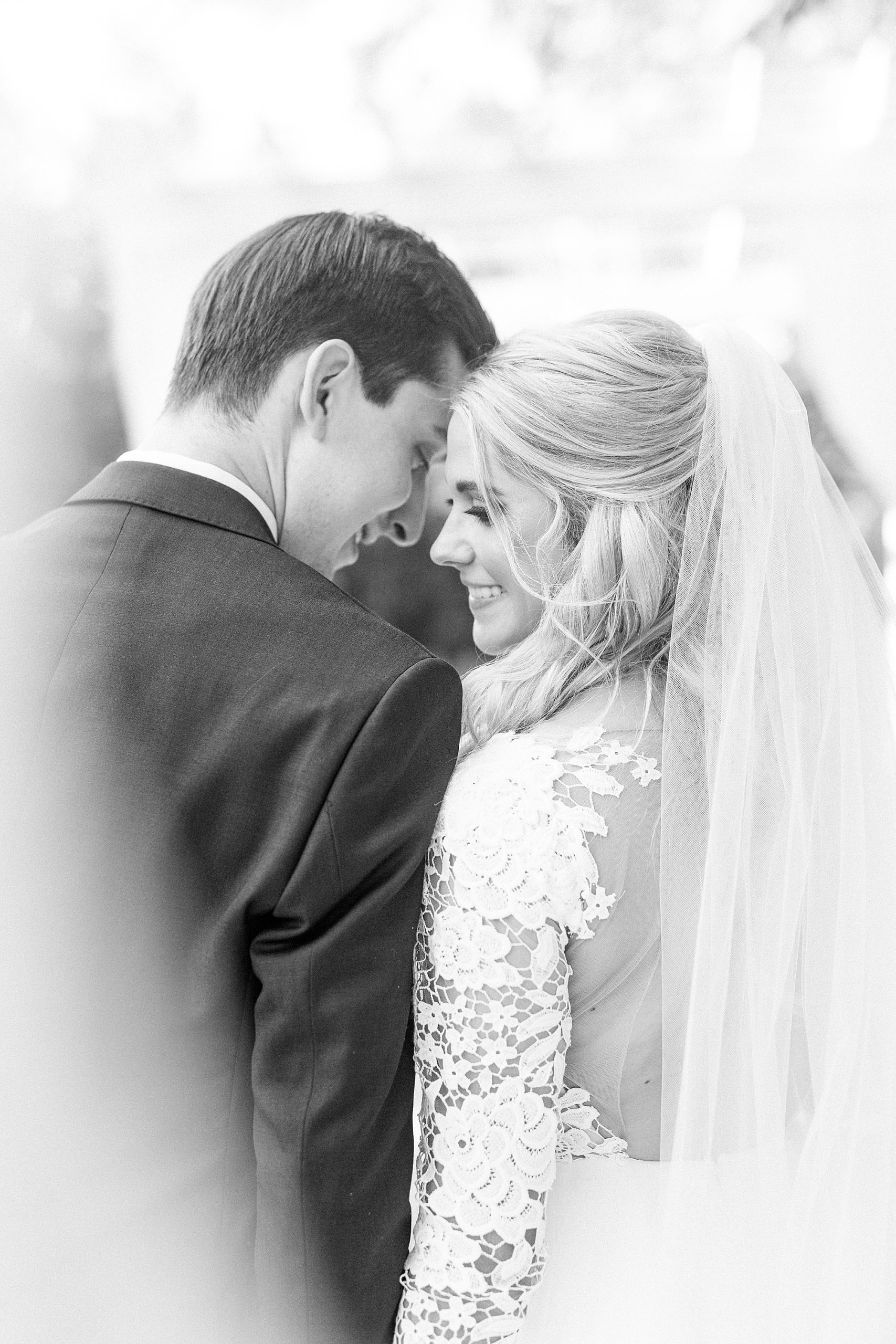 bride looks over groom's shoulder during portraits at Separk Mansion