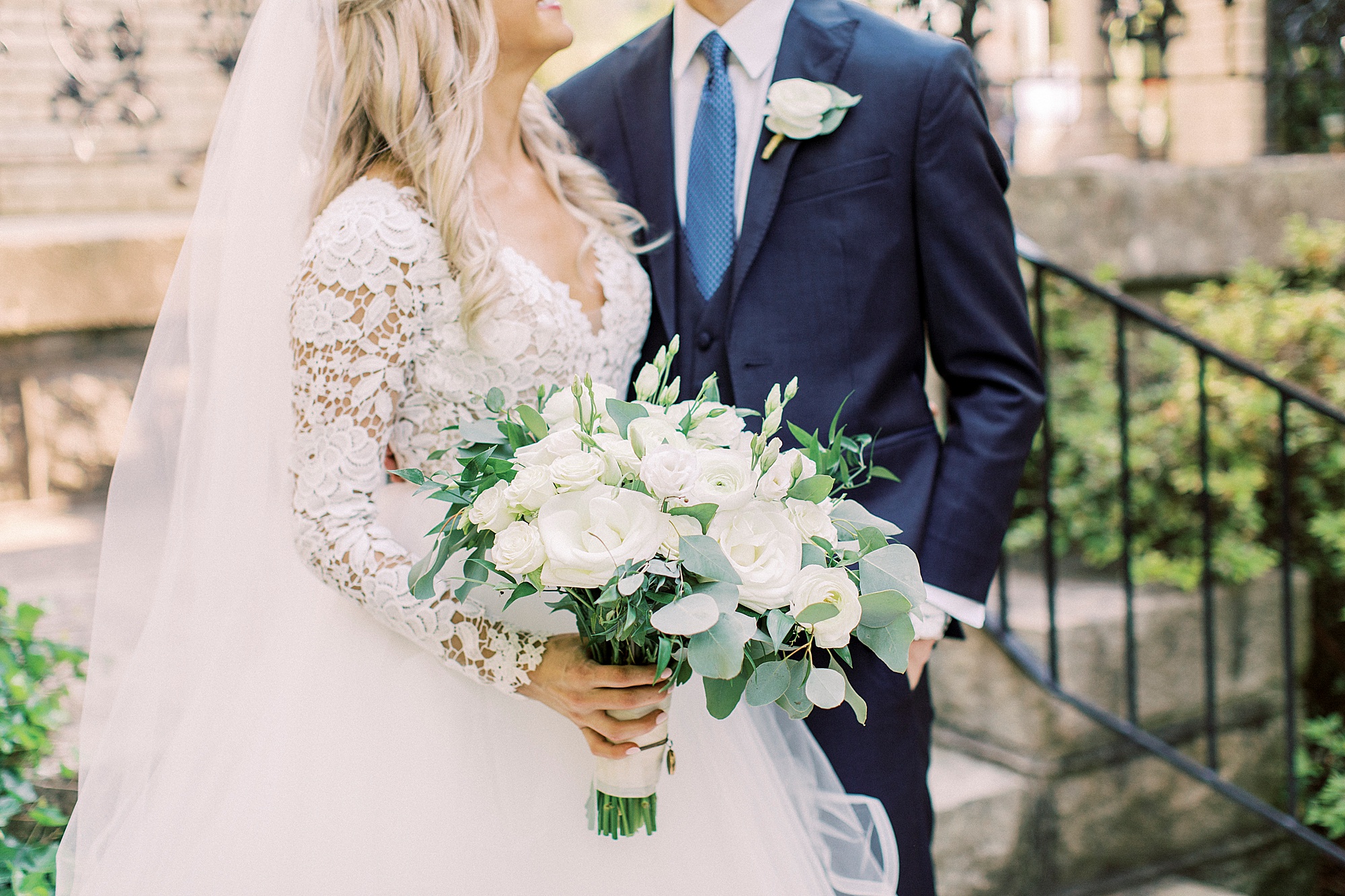 bride and groom pose by steps at Separk Mansion