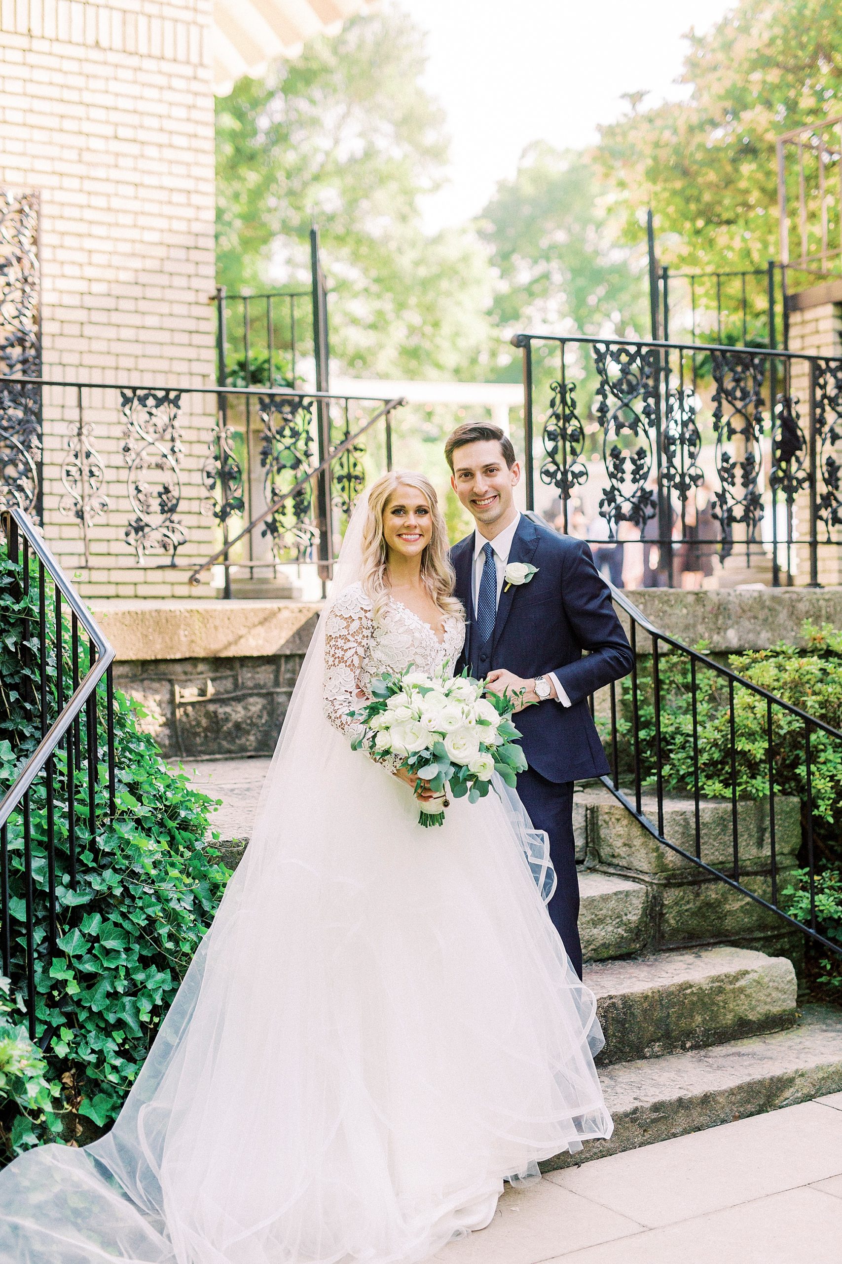 bride and groom pose by steps at Separk Mansion