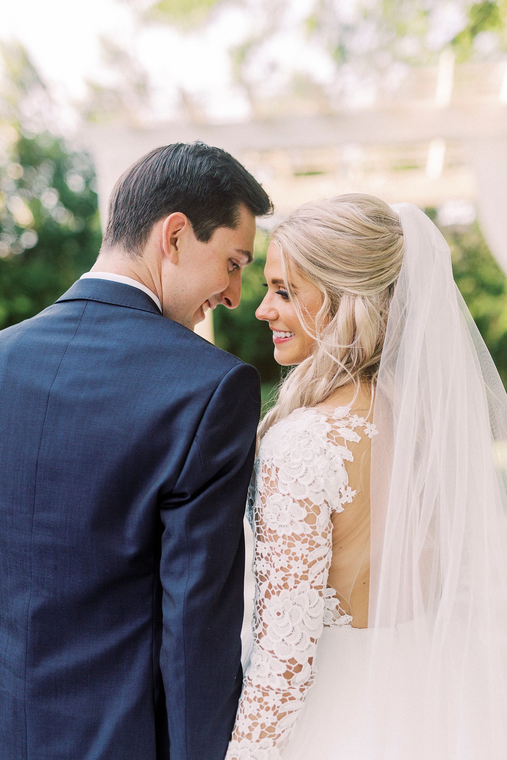 groom touches foreheads with bride in Hayden Olivia bridal gown