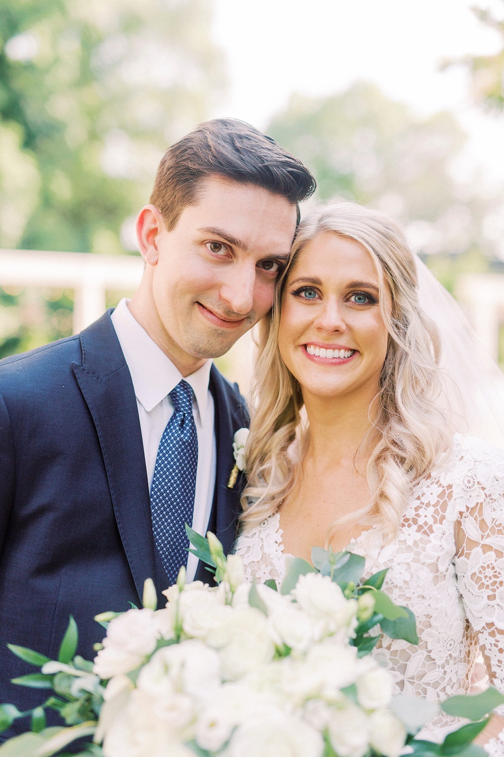 Charlotte NC couple poses with heads touching during wedding photos
