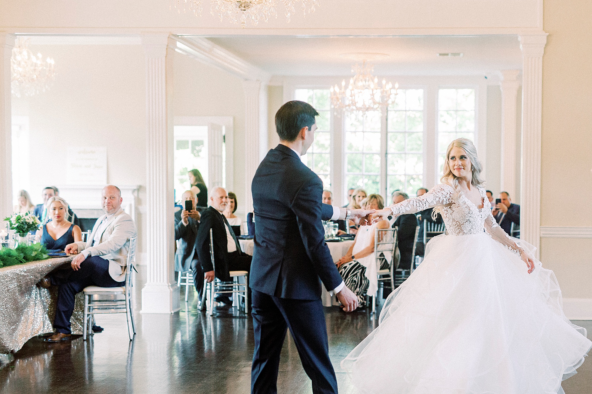 groom twirls bride in Hayden Olivia bridal gown