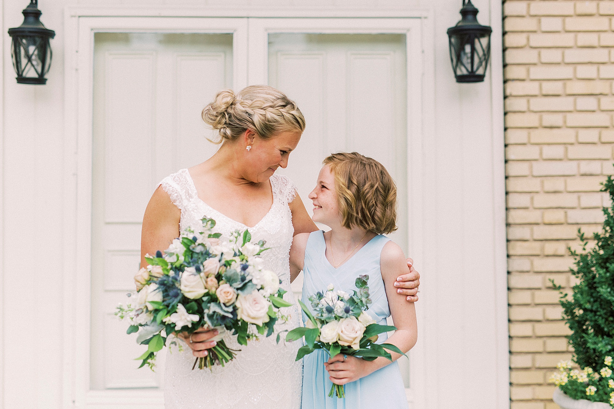 bride hugs junior bridesmaid in gardens of Separk Mansion