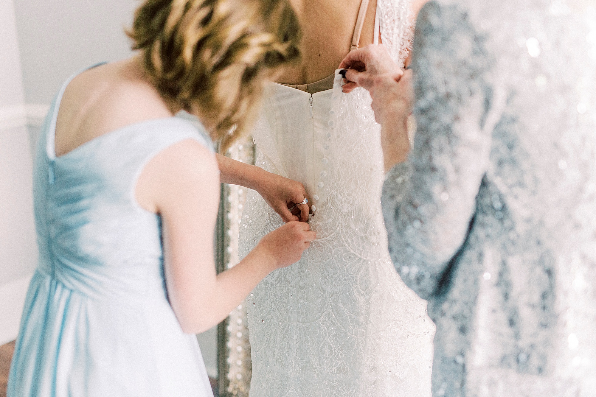 daughter and mom help bride with wedding gown for Separk Mansion wedding