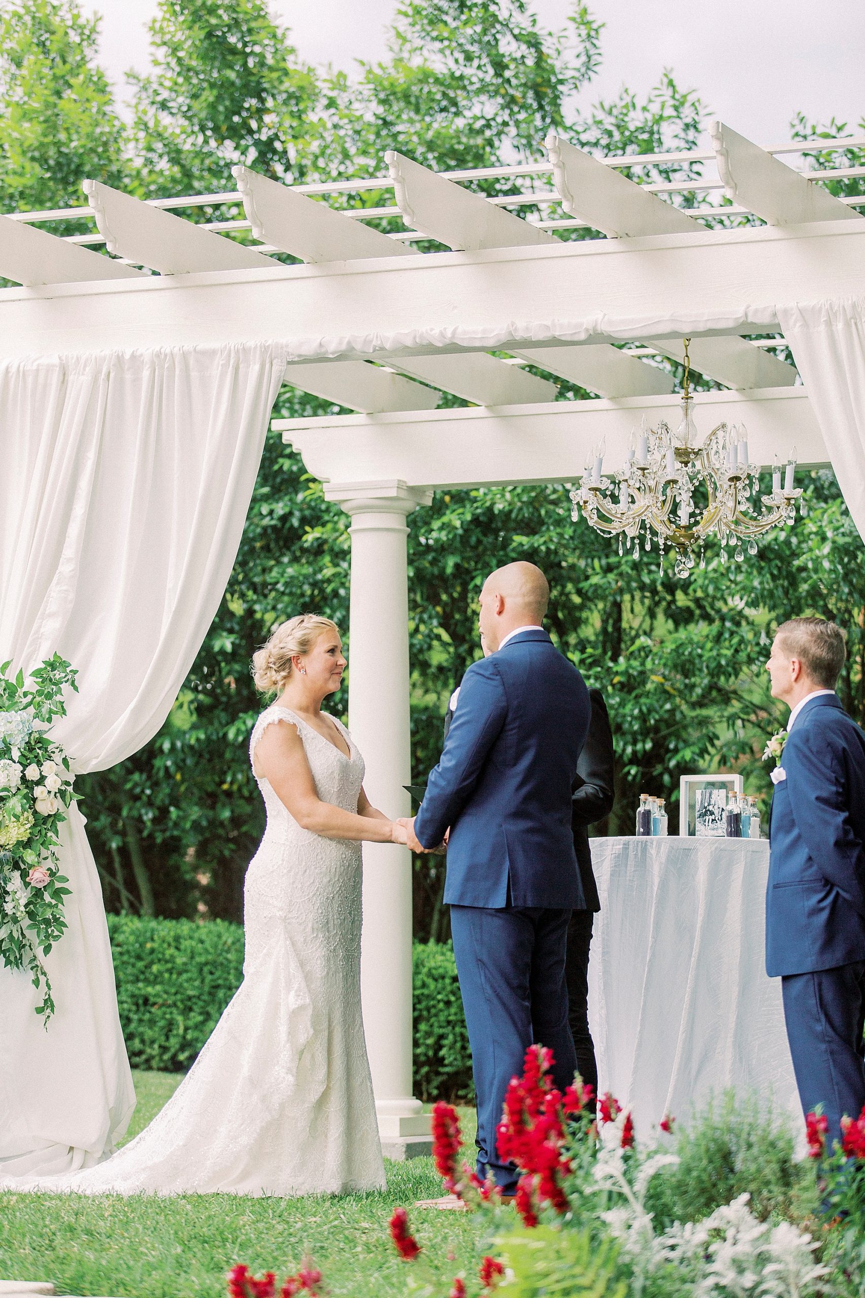 bride and groom hold hands during outdoor ceremony in Charlotte NC