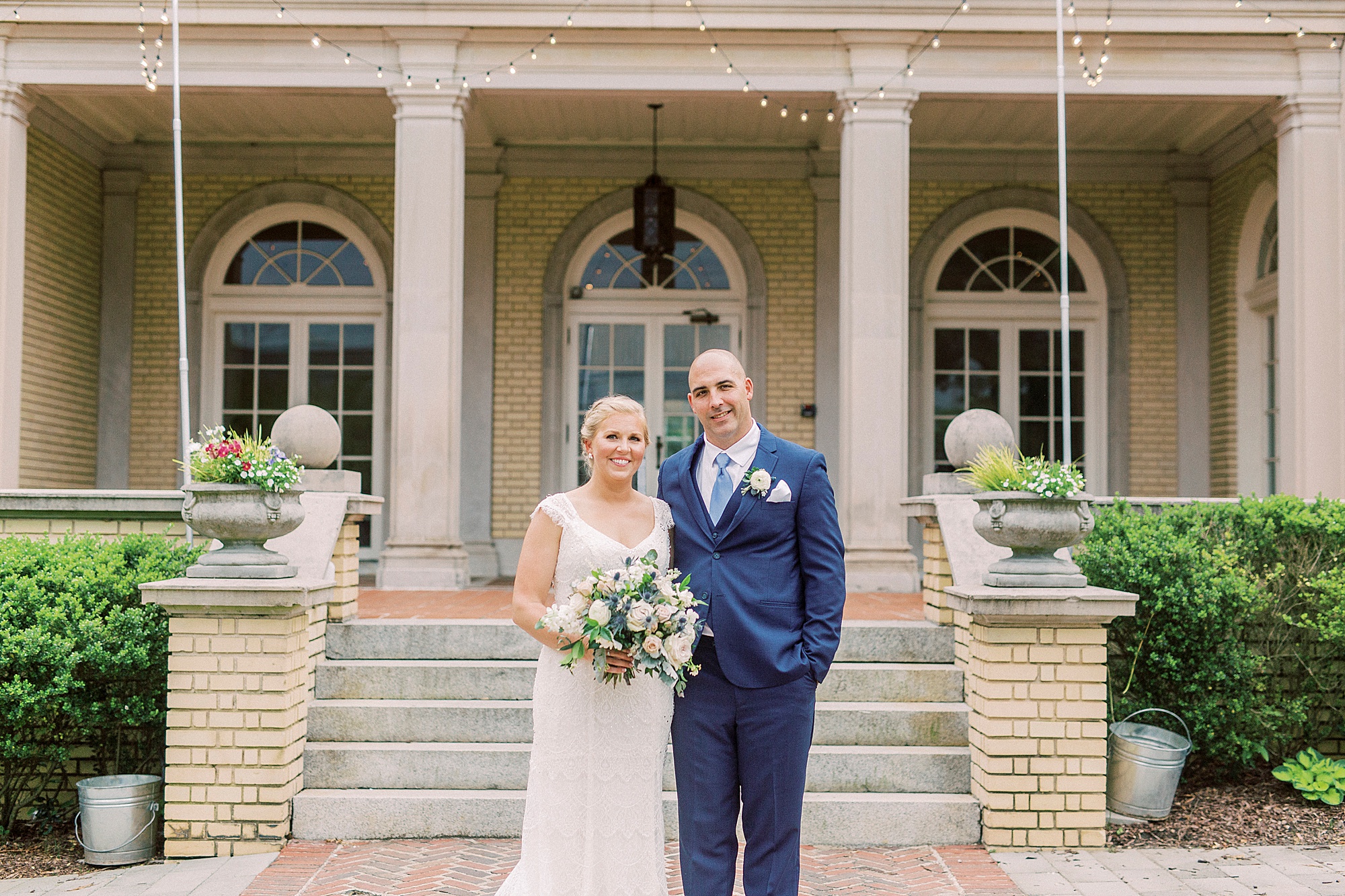 bride and groom stand by steps outside Separk Mansion