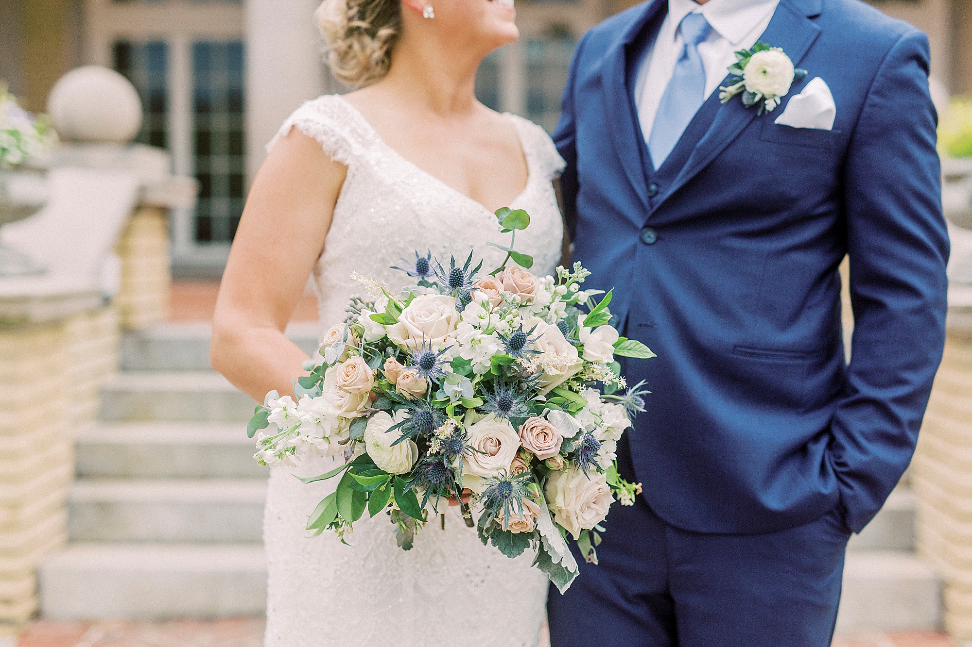 bride holds bouquet of white and pink flowers