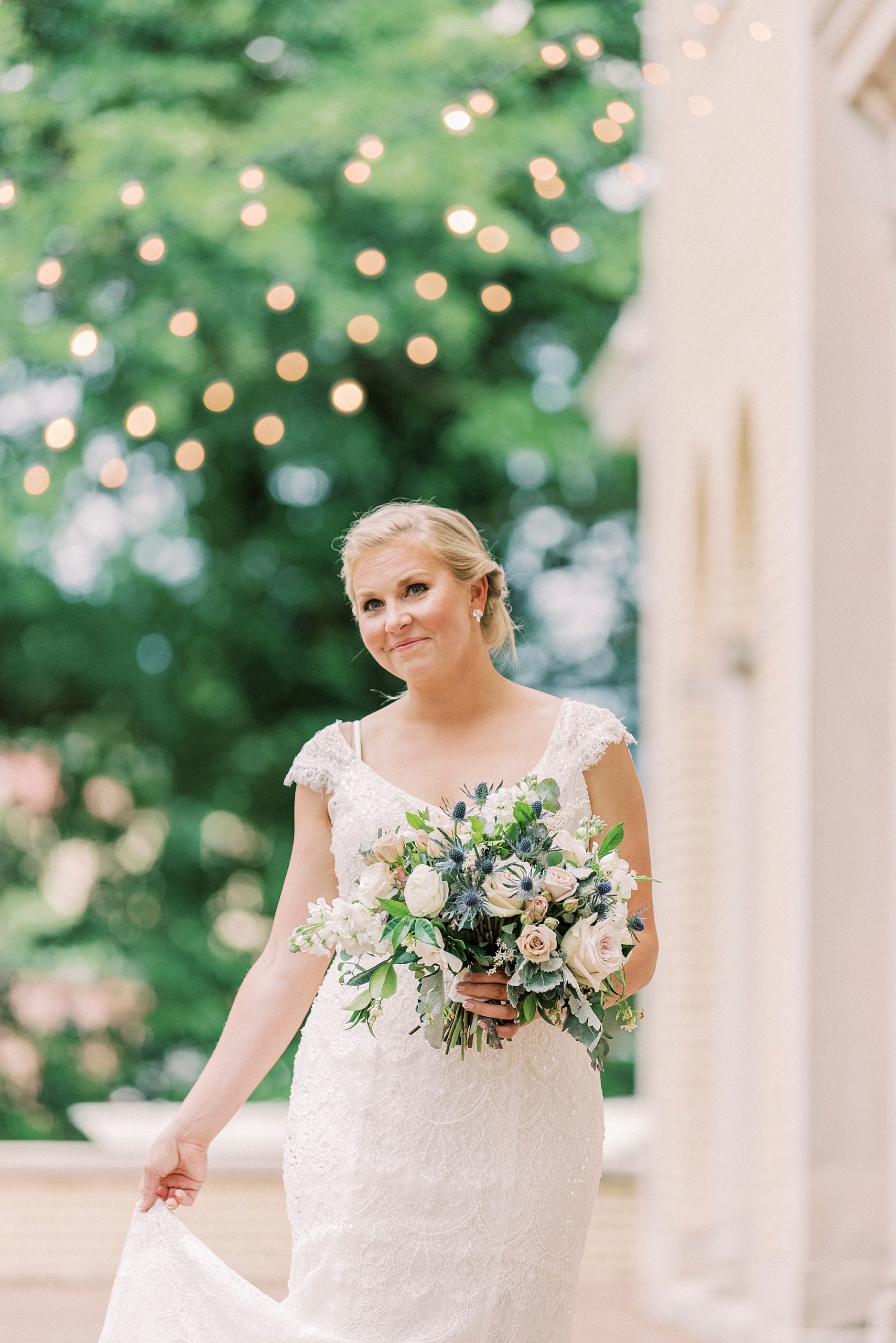 bride poses by patio lights outside Separk Mansion