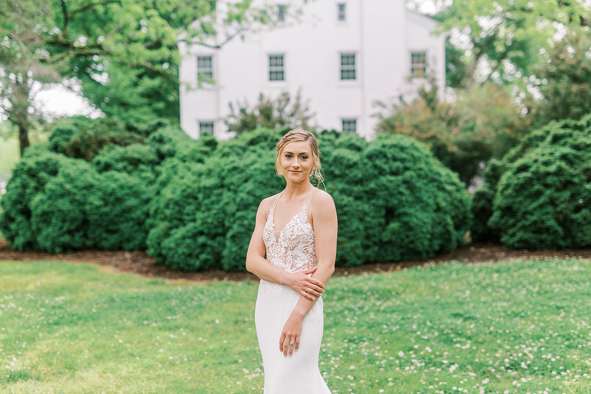 bride holds arm across stomach during Tanglewood bridal portraits