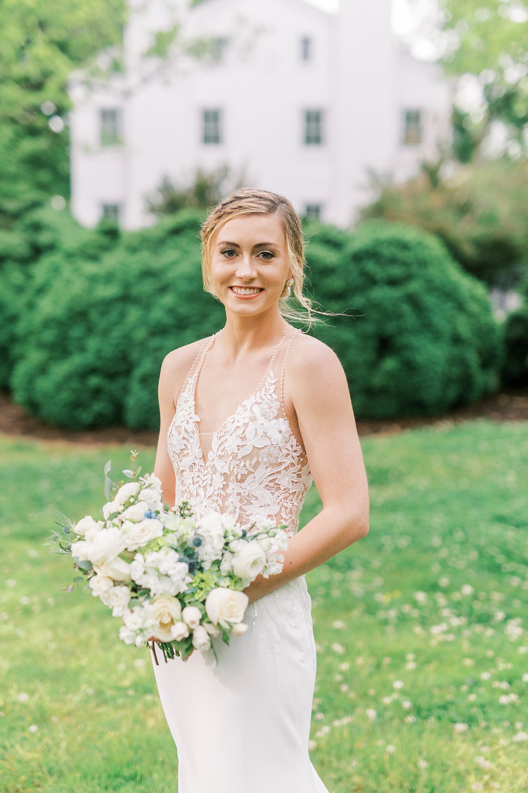 bride holds bouquet of white flowers