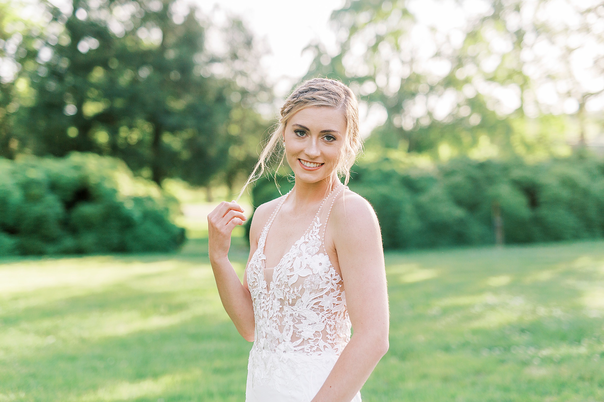 bride twirls hair around finger during Tanglewood bridal portraits